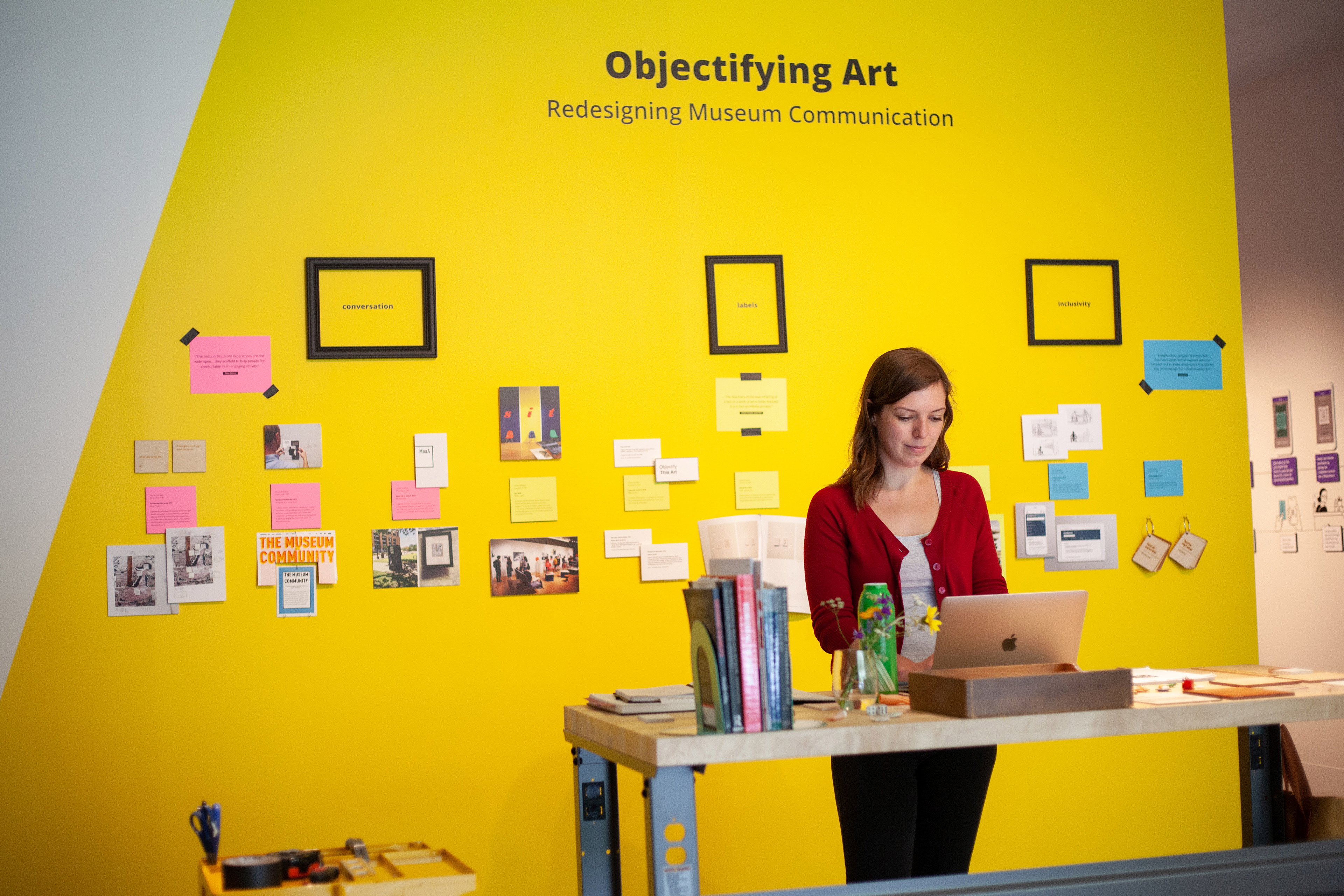 A photo of me working at my desk, in my portion of the exhibition.