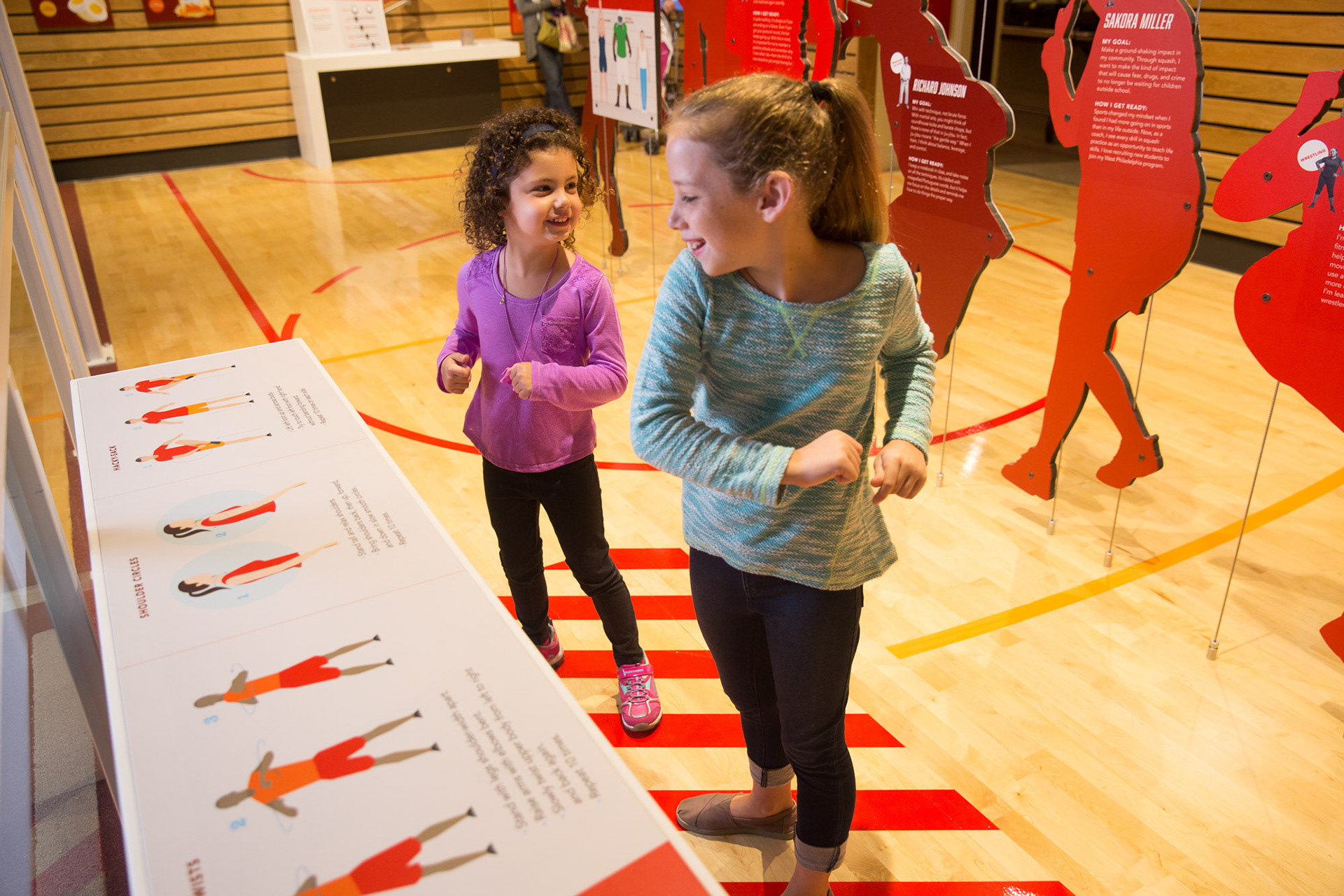 Young visitors interactive with the "warm up" content panel.