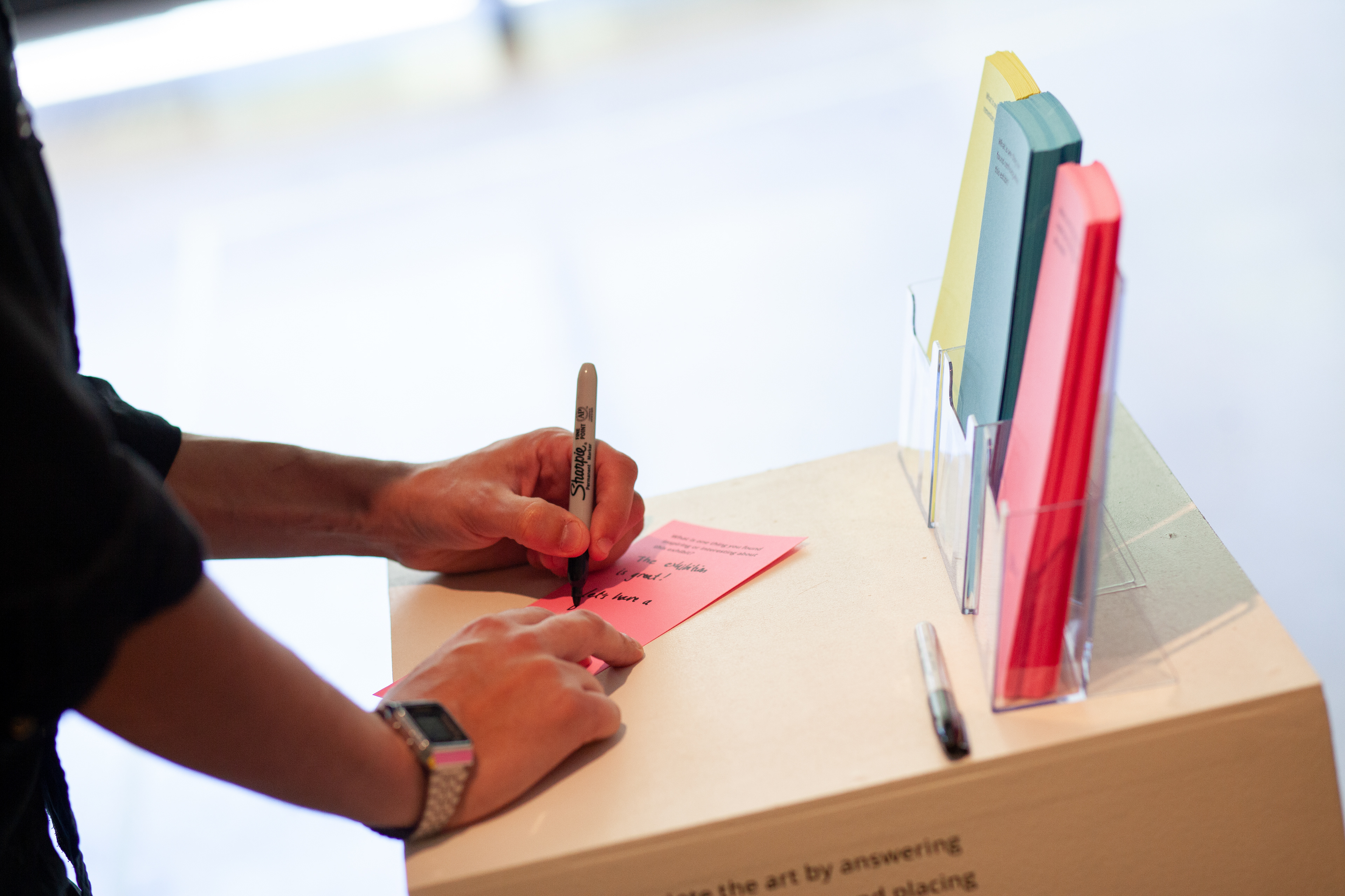 Visitor filling out one of the prompts.
