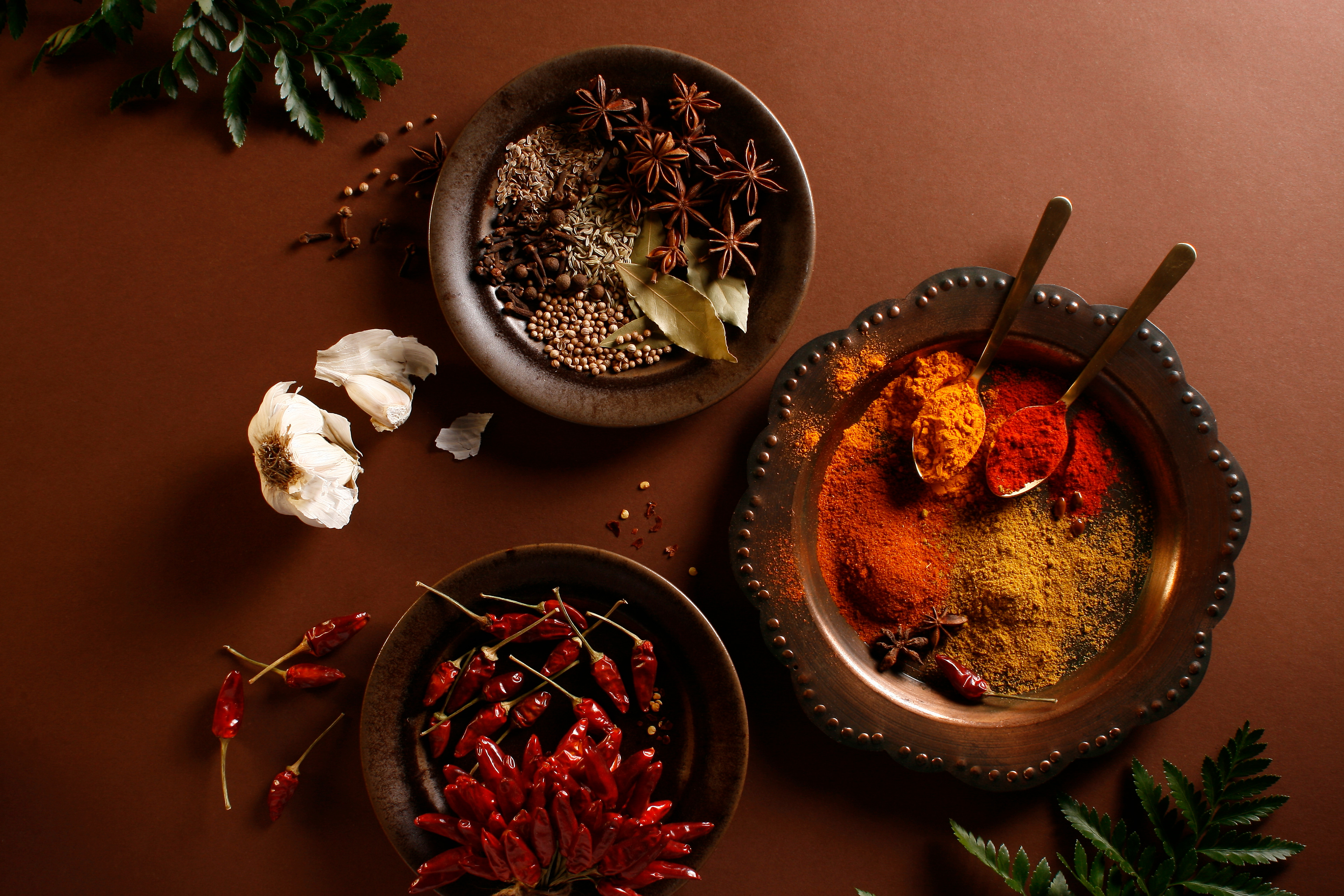Photo of colorful Indian spices on brown moody background Captured by Marialex Moncada in Budapest