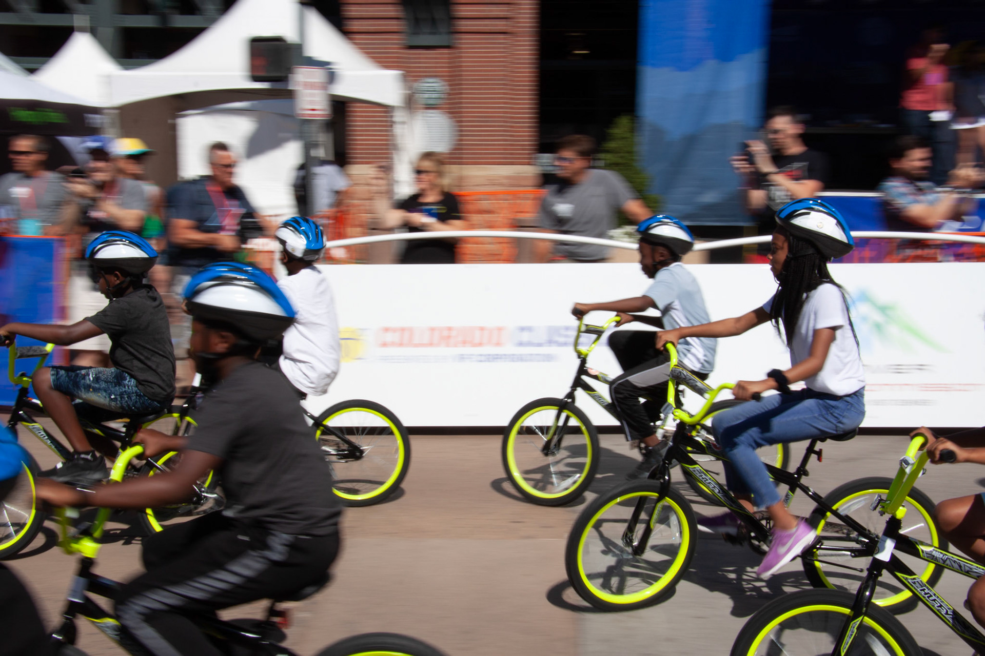 Kids ride their new bikes on the race course