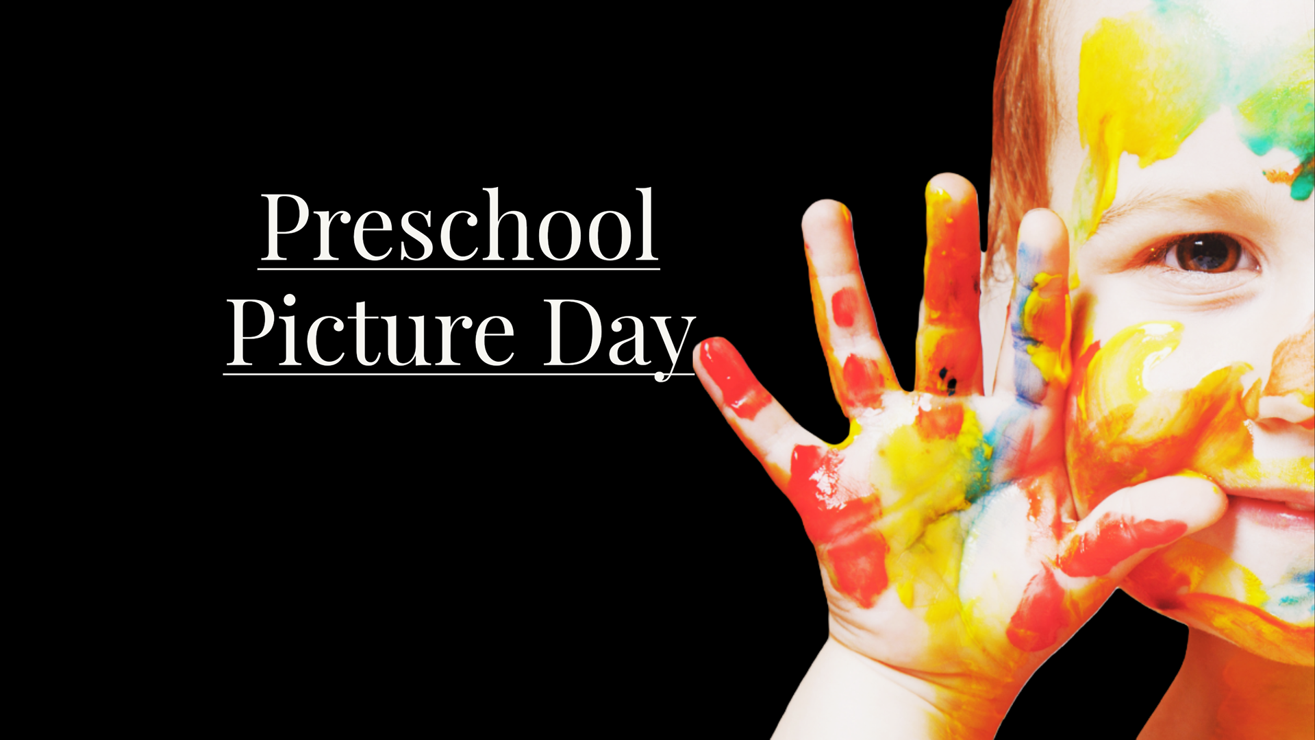 Smiling toddler covered in primary colored finger paint in various colors. Holds his little  hand up  by his cheek and waving hello.
