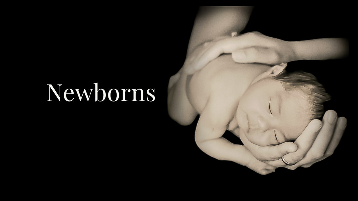 Naked Newborn baby sleeps in parents hands