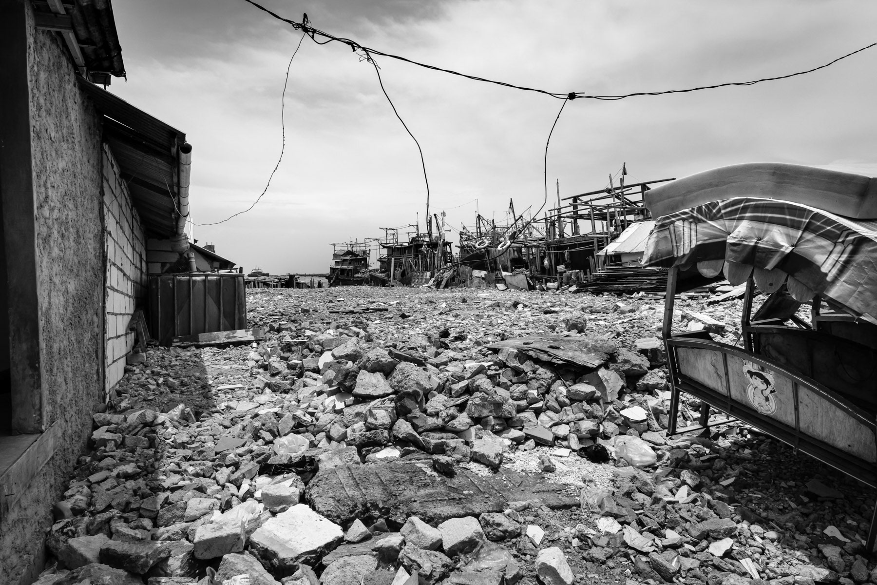 Land plot from where people were evicted . Land rights and land ownership is a big issue affecting mainly poor families from the fishing community. Soil sinking, rising sea levels and floods make their survival even more precarious. Muara Angke neighbourhood, North Jakarta, Indonesia, March 2020