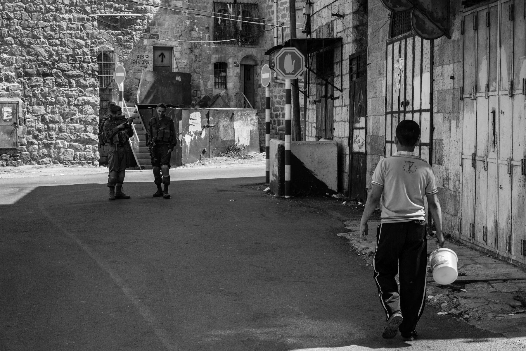 Palestinian boy walking through the sealed-off area of Shuhada street in Hebron, Palestine, August 2013