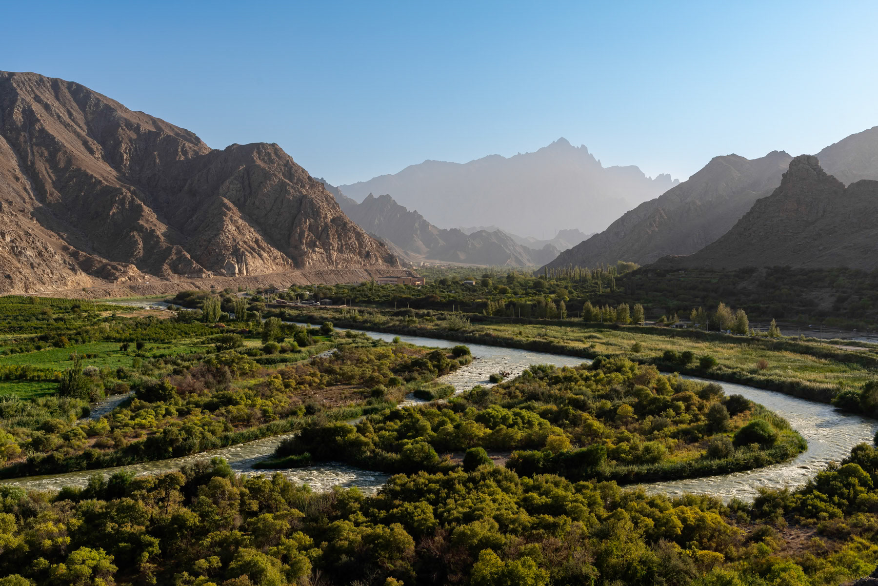The Aras River marks the natural border between Armenia and Iran. This is also where the famous Zangezur Corridor is expected to pass on the Armenian side, connecting Azerbaijan to its Nakhchivan exclave, which is visible in the background. Meghri, Armenia, September 2025