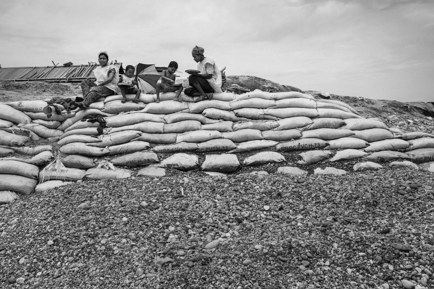 Stone diggers taking their lunch, Bholaganj along the Dholai river, Bangladesh, May 2016