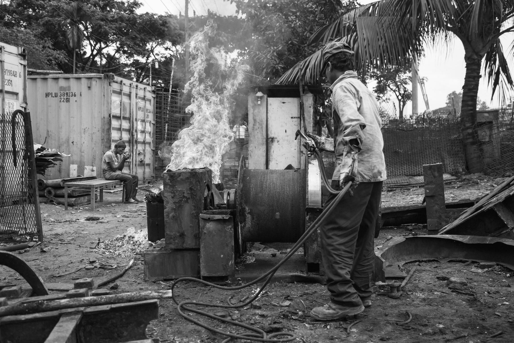 Cutting heavy ship parts and burning plastic of electrical cables. Kumira ship breaking yards, Bangladesh, October 2014