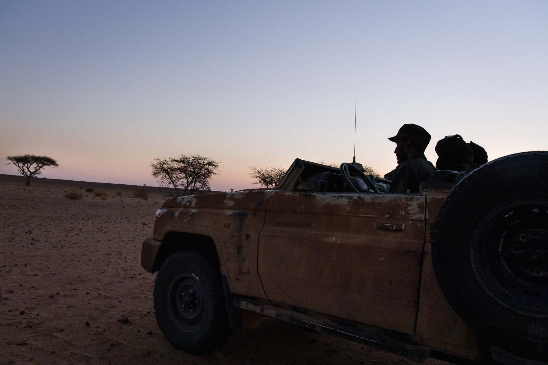 Sahrawi military going on early morning reconnaissance in an undisclosed location near the frontline in the second militarty region of the Sahrawi Arab Democratic Republic (SADR). Vehicles have their roof cut out and body parts are smeared with mud and sand in order to be less reflective against drone attacks. Undisclosed location in the liberated territories of the Western Sahara, October 2021