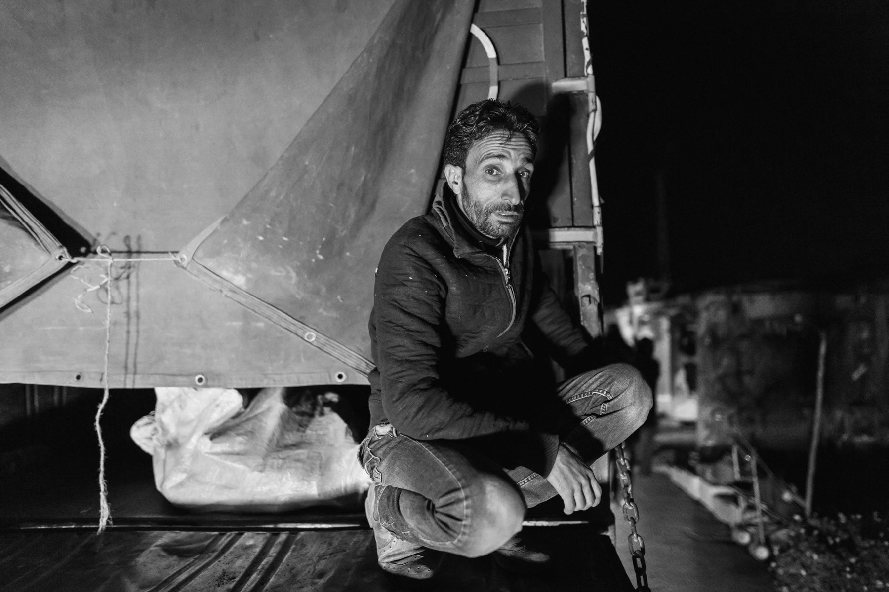 Syrian volunteer helping to distribute firewood to isolated Syrian refugees in the Bekaa Valley, Lebanon, March 2016