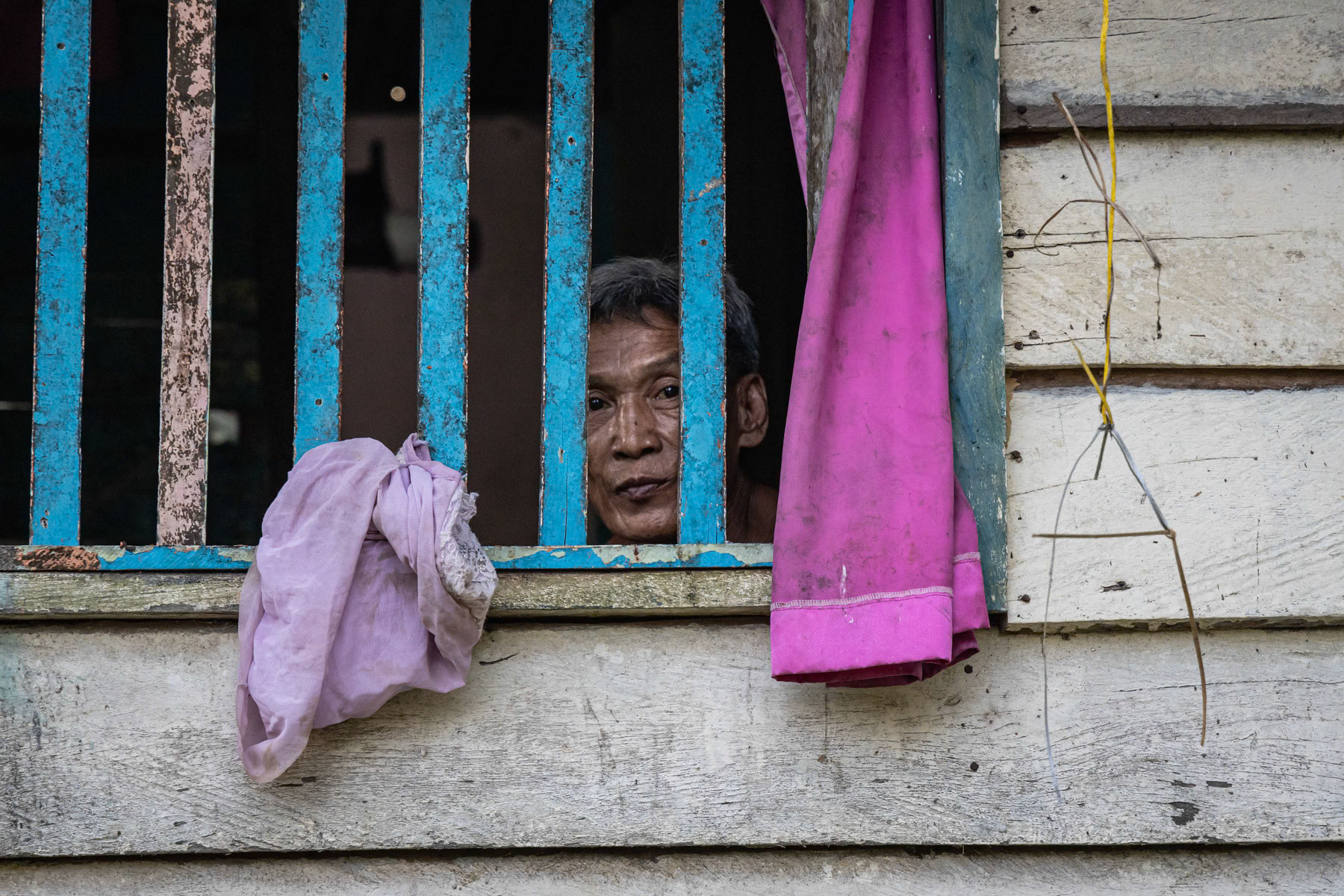 Resident of Belaga, an outpost town at the edge of the rainforest of Borneo and inhabited by several indigenous tribes that have been re-settled there during the past decenia. Belaga town, Sarawak, Malaysia, June 2022