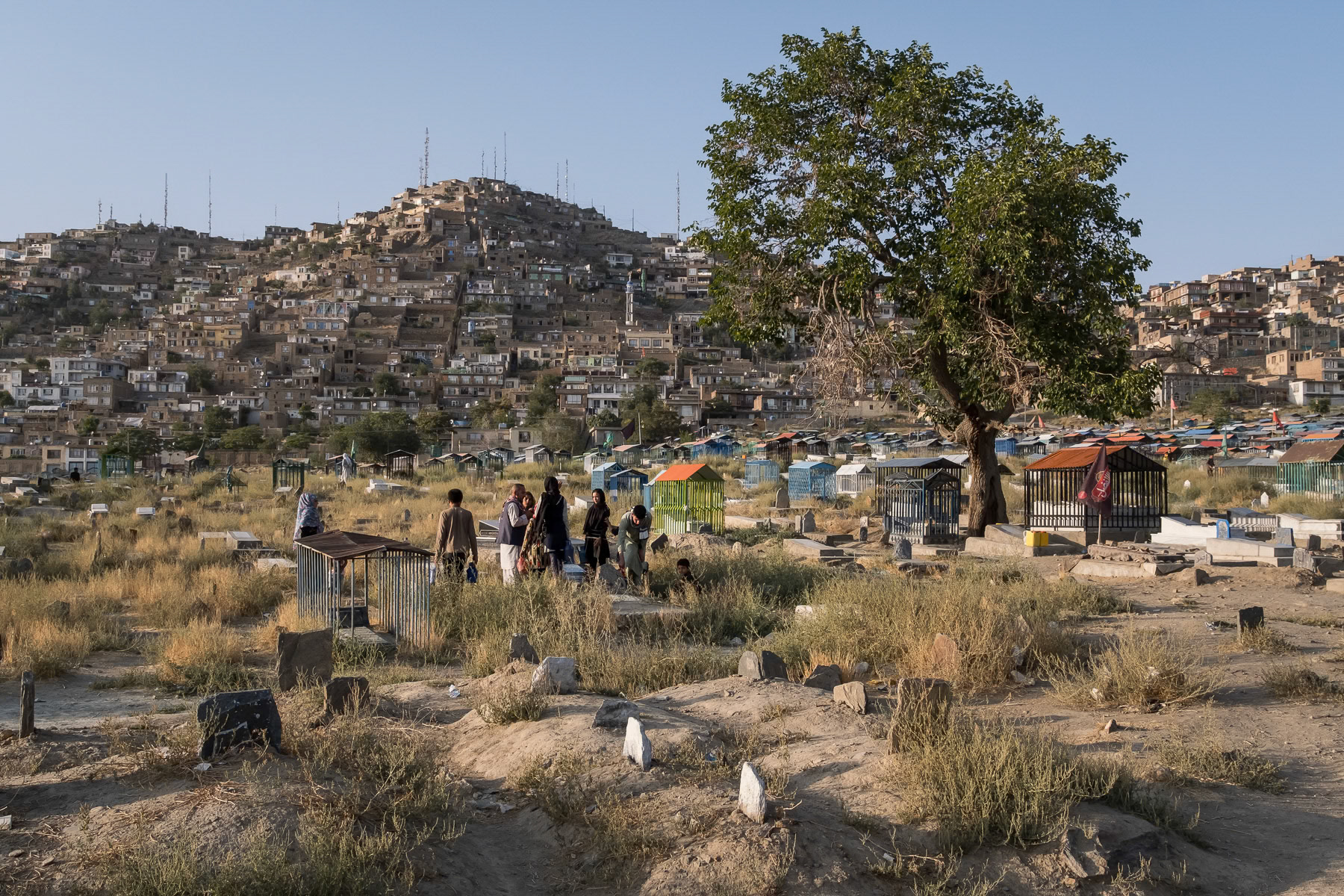 Hazara grieving at a Shia graveyard in Kabul. Sakhi shrine in Kabul, August 2024