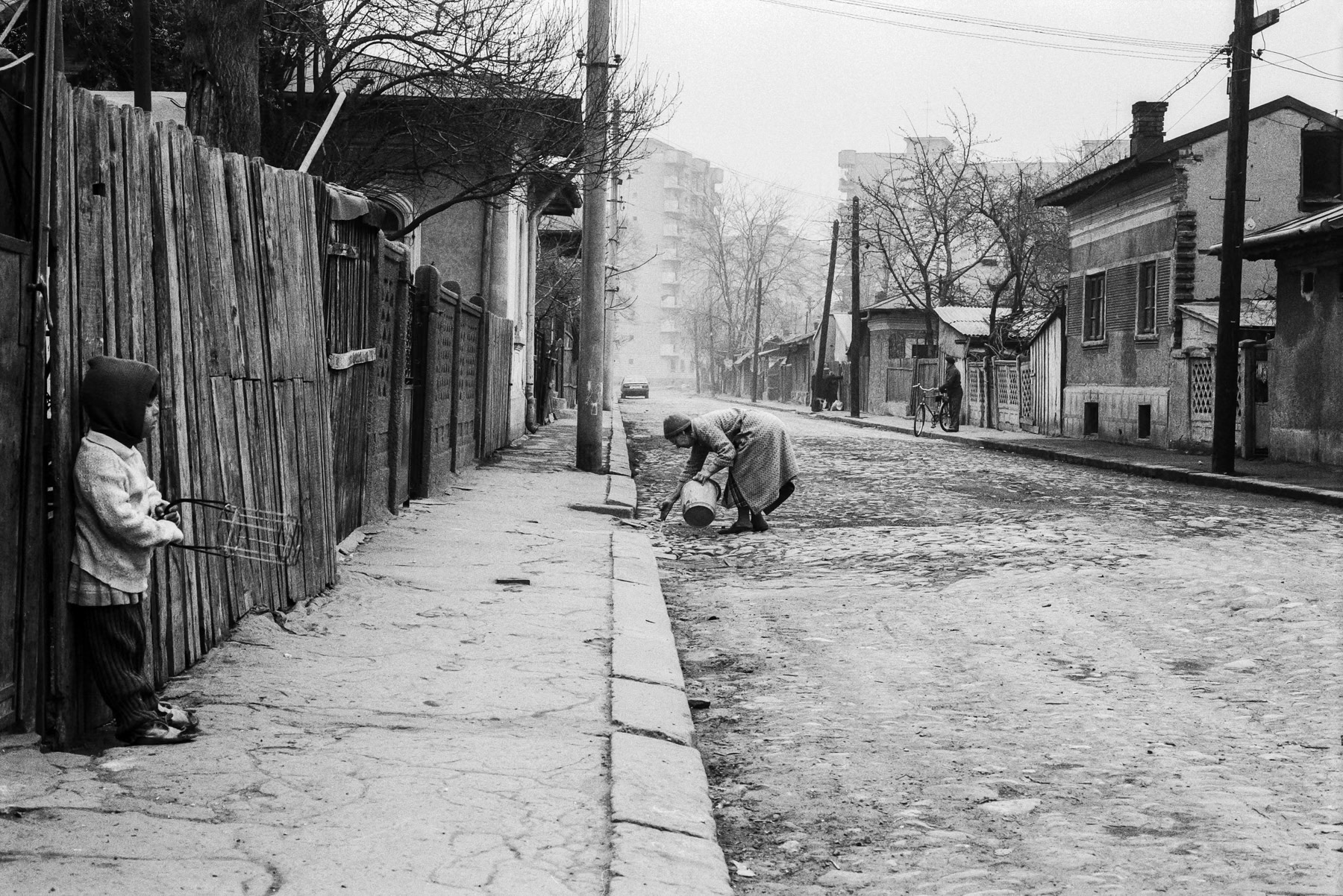 Old neighbourhood being gradually overtaken by new apartment blocks, Bucharest, April 1991