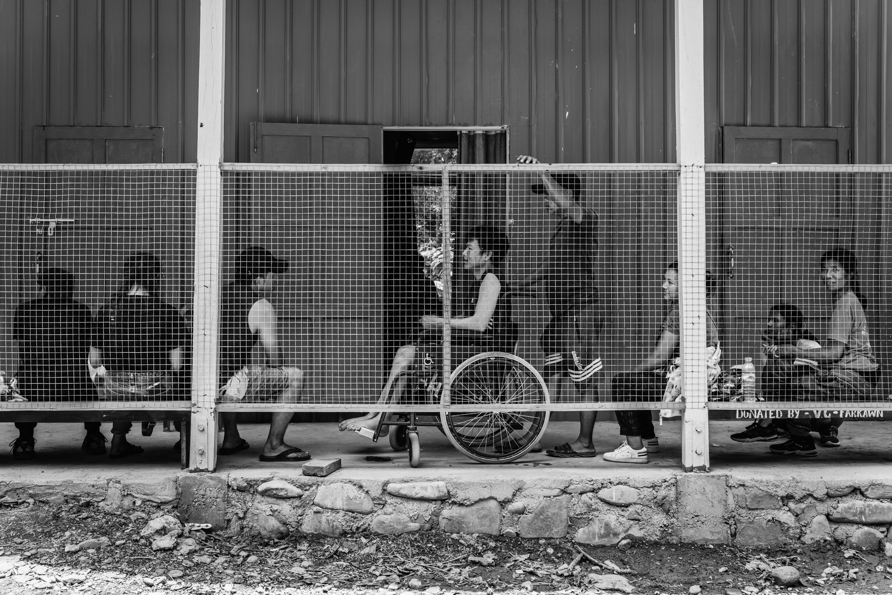 Patients waiting at the outpatient ward of a military hospital in Chin State. Beside combatants of the Chin National Army, many civilians are being treated at the hospital. Being one of few functioning hospital in Chin State, people do often travel 2-3 days before reaching it. Chinlung in Chin State, Myanmar, April 2024