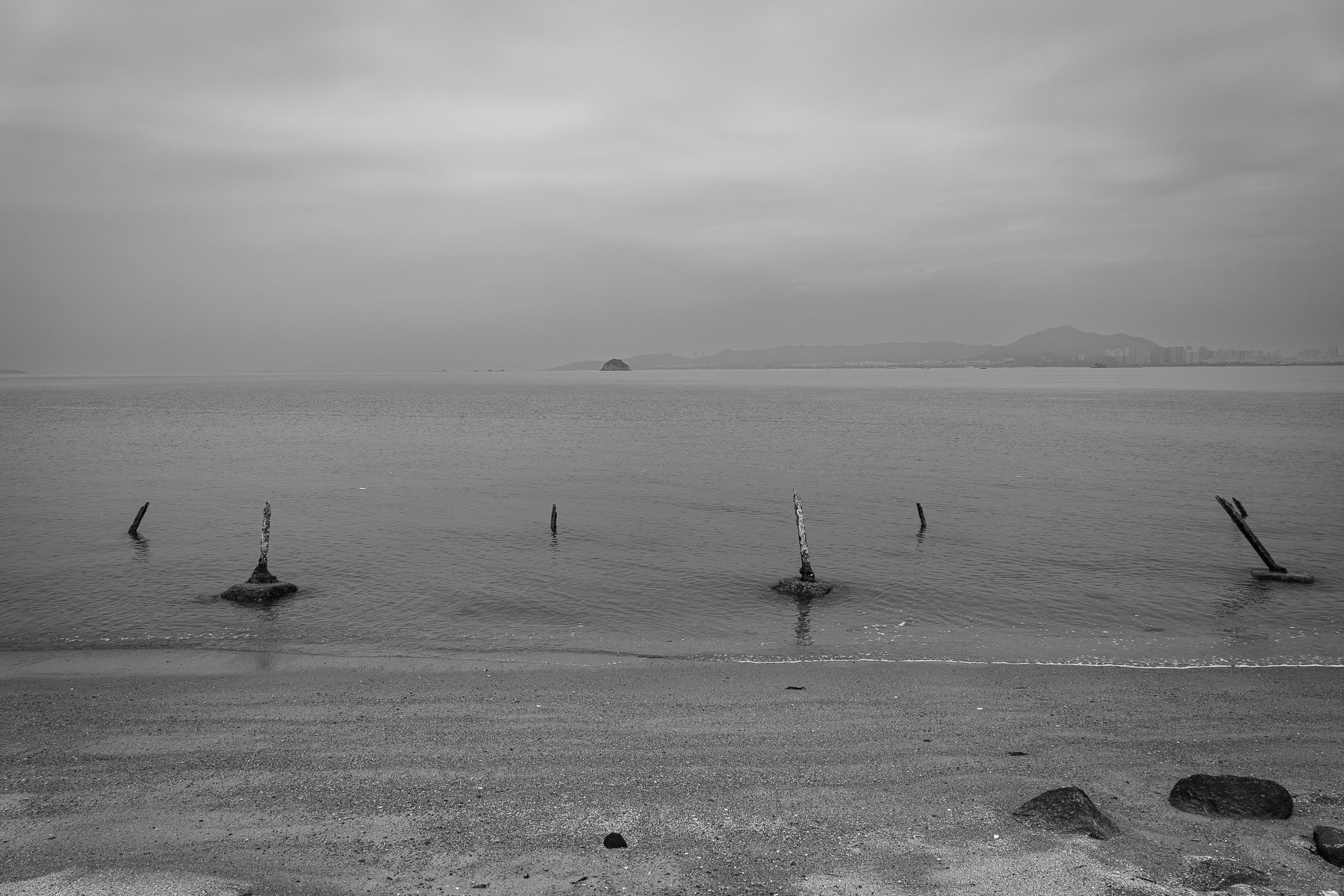 Iron sticks pierce Kinmen's beaches, a stark defense against potential landings. Lieyu beach, Kinmen island, Taiwan, May 2025