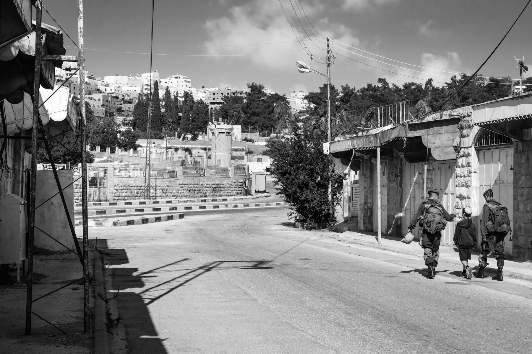 Child being escorted through Shuhada street in the divided city of Hebron, Palestine, July 2013