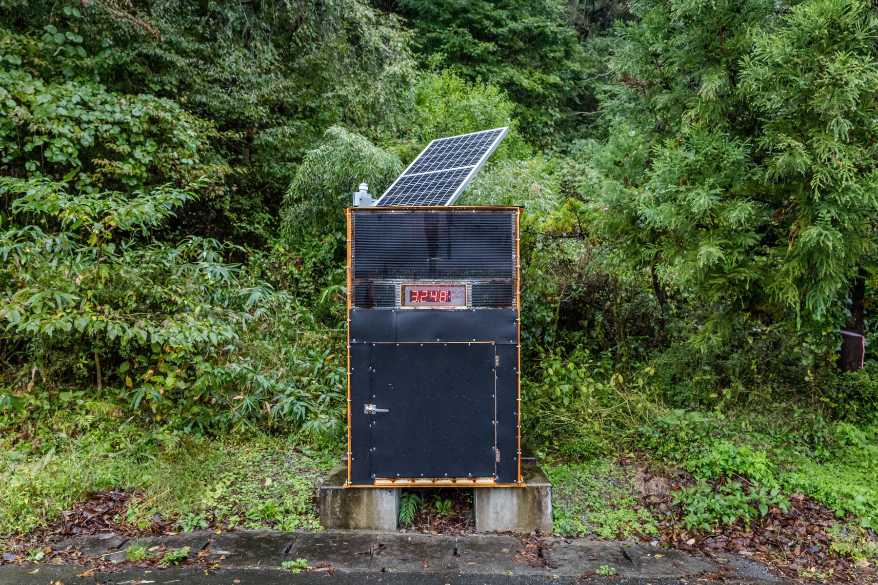 Radiation level indicator along route 50 crossing the mountains. The entire area in the woods and mountains are no go zones as radiation levels are still to high. Those areas in the hinterland will most likely remain off limit forever. Route 50 between Namie and Katsurao. Fukushima Prefecture, Japan, October 2019