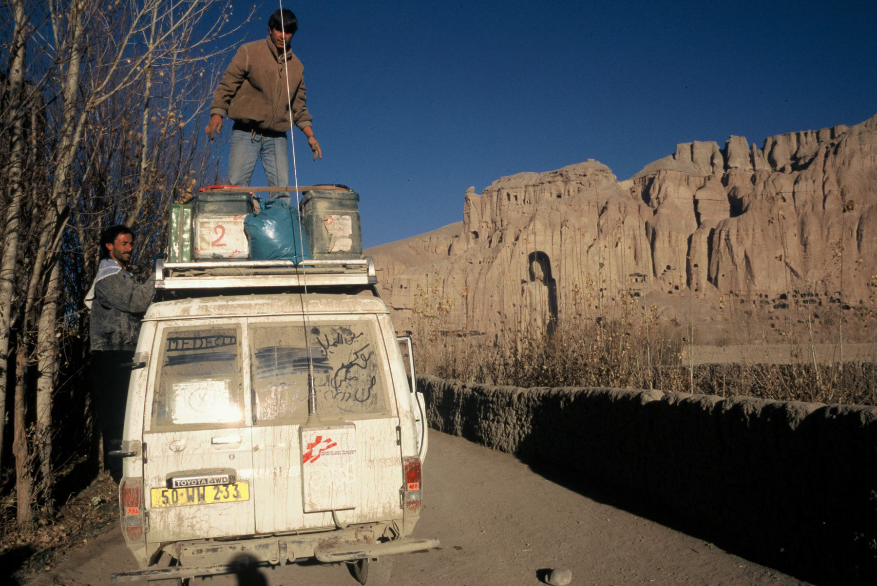 MSF vehicle being with the Buddha site in the background. The Buddha statues were destroyed by the first Taliban regime in 2001. Bamyian, Afghanistan, 1995
