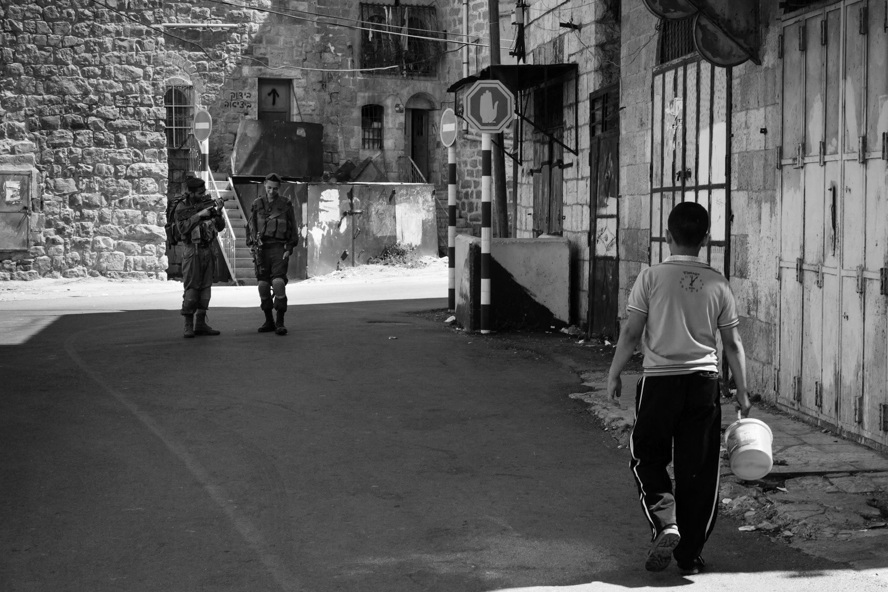 Palestinian boy walking through the sealed-off area of Shuhada street in Hebron, Palestine, August 2013