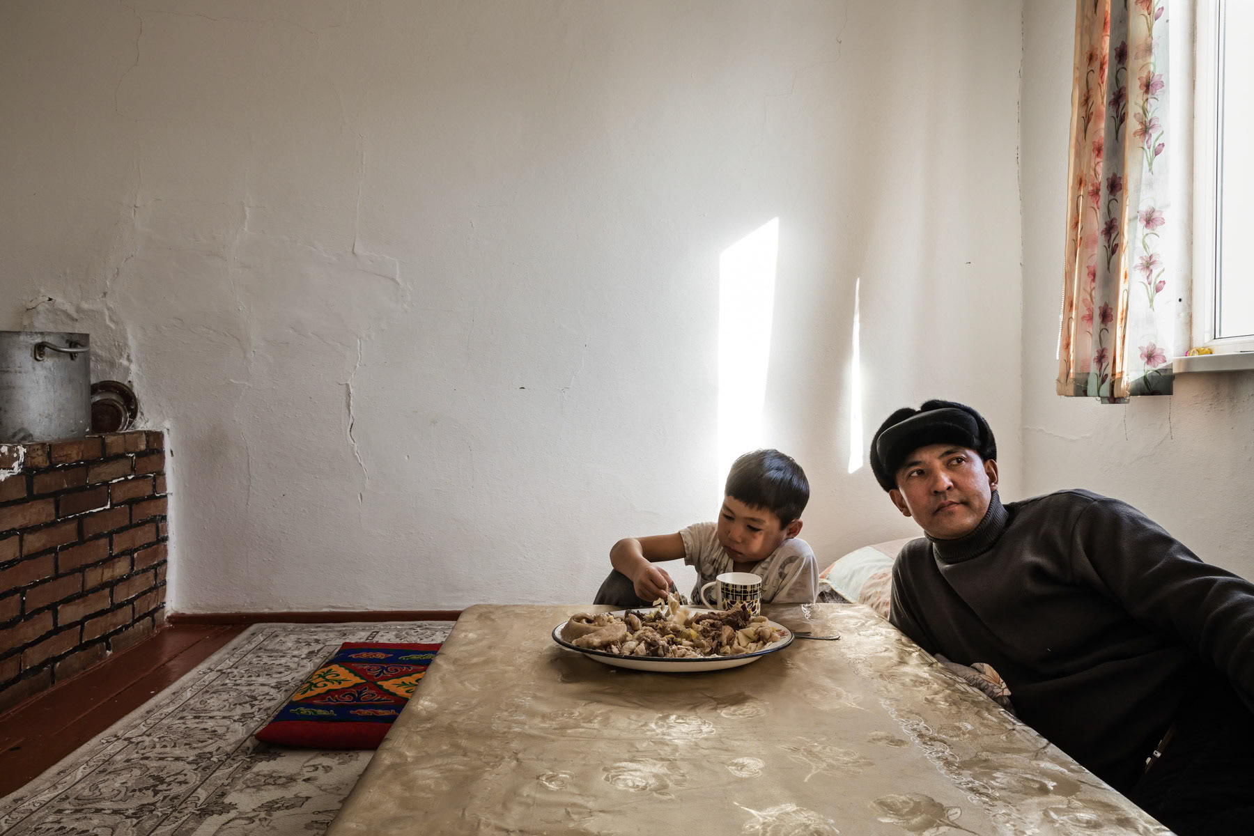 A boy eating camel meat. Tastubek, Aral Sea, Kazakhstan, January 2019