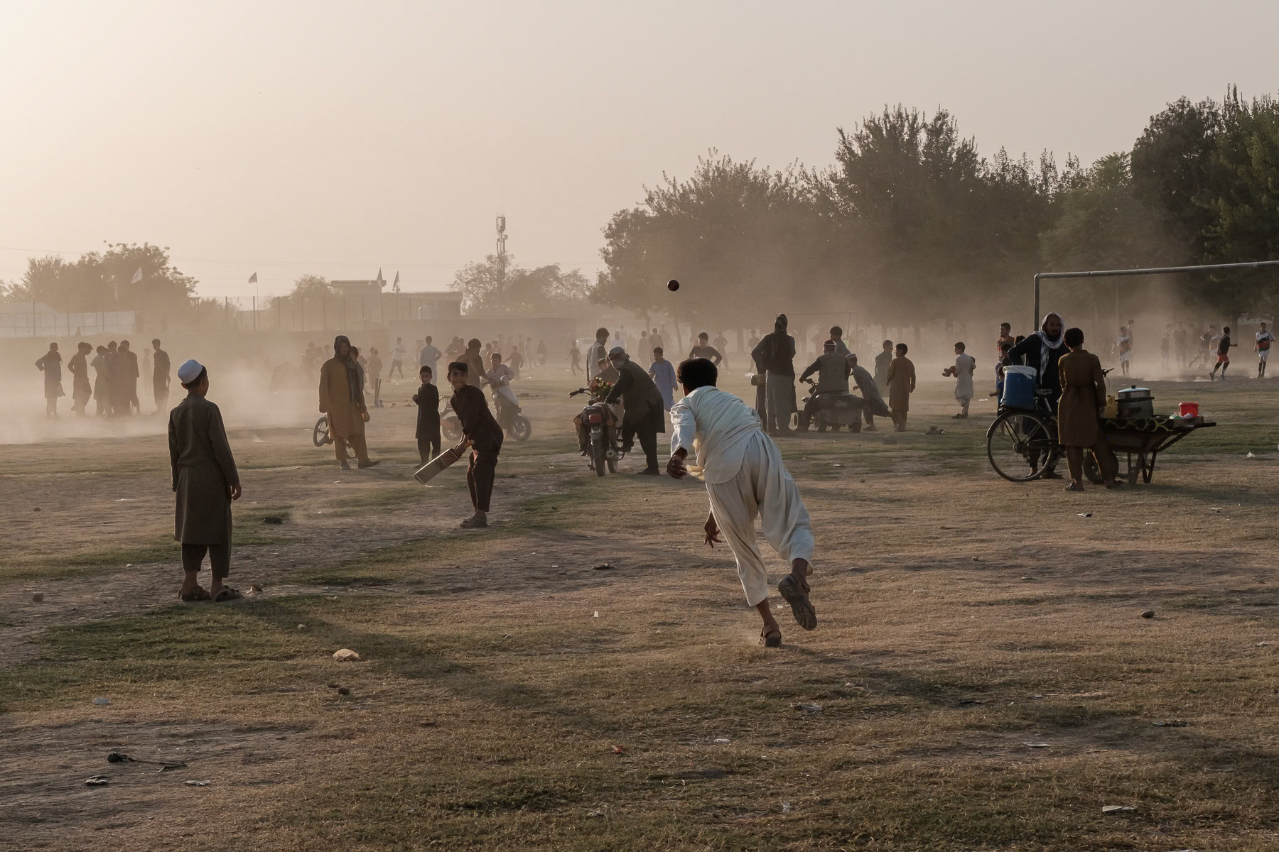 Afghan boys playing cricket. Cricket has become during the past 30 years the most popular sport in Afghanistan and is now widely practiced in all regions of the country. Kunduz, Afghanistan, September 2024