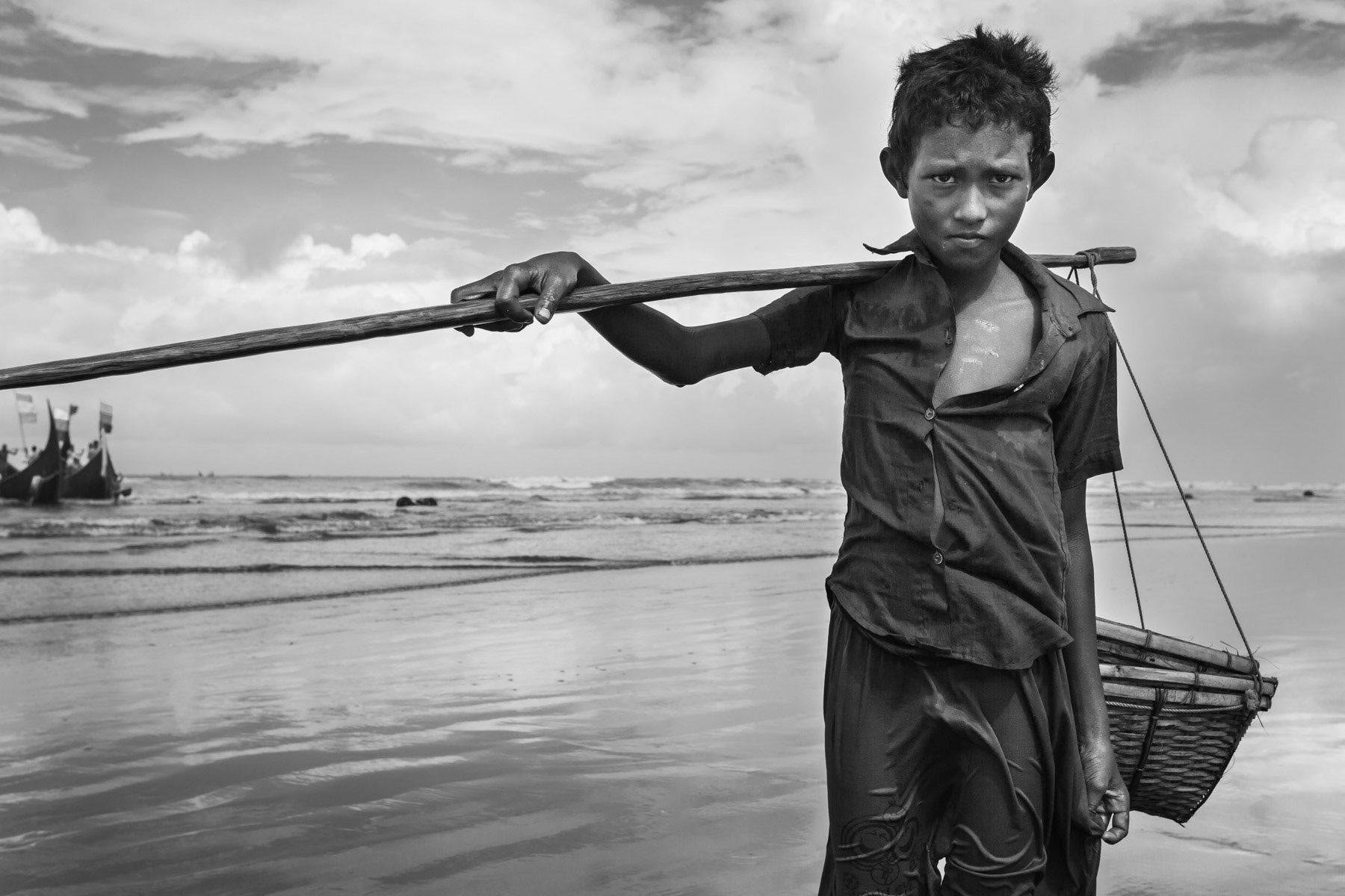 Rohingya refugee working as underpaid daily labour for Bangladeshi fishing boat owners. Shamplapur, Bangladesh, June 2015