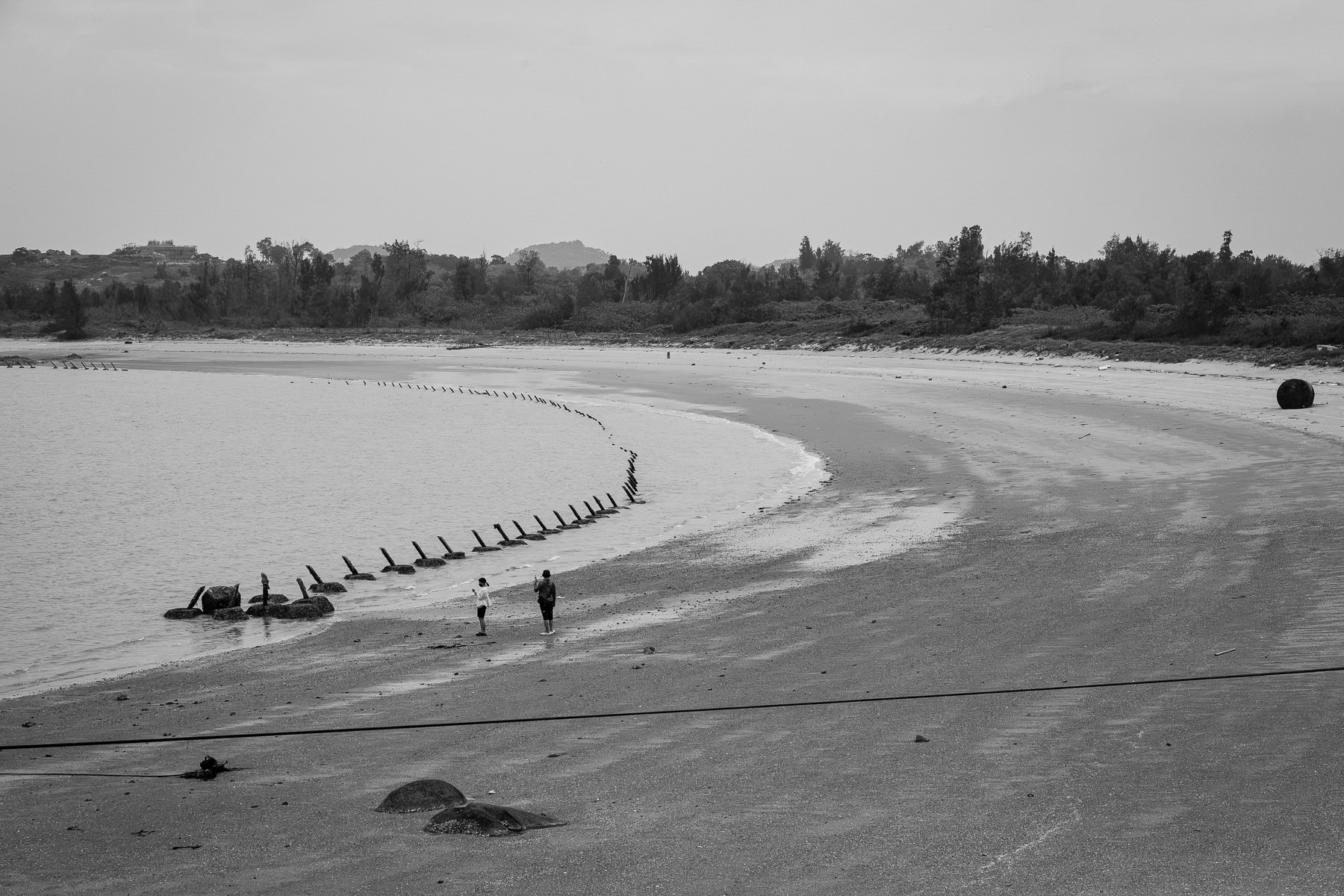 Iron sticks pierce Kinmen's beaches, a stark defense against potential landings. Jinsha beach, Kinmen island, Taiwan, May 2025