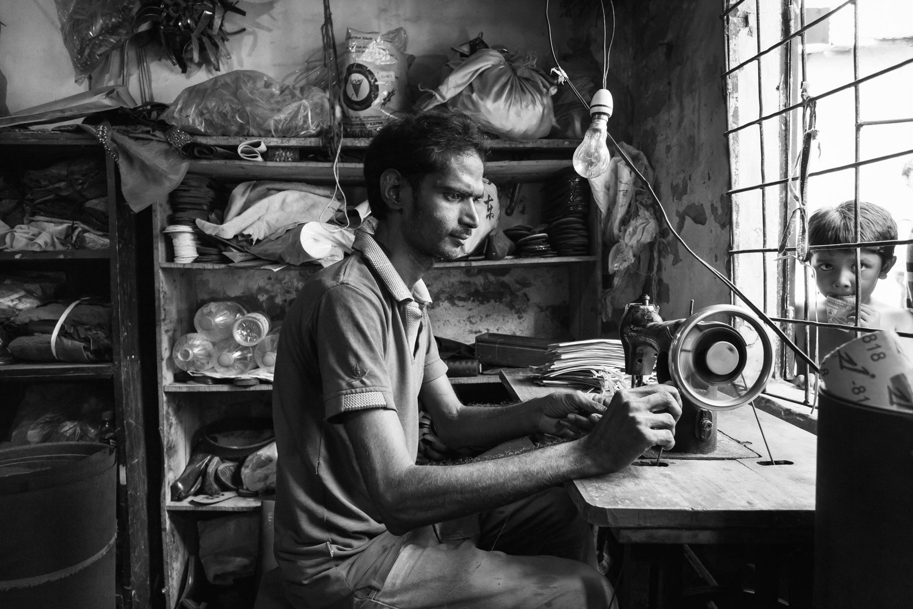 Small shoe shop, Bihari community in Mirpur, Dhaka, Bangladesh, May 2015