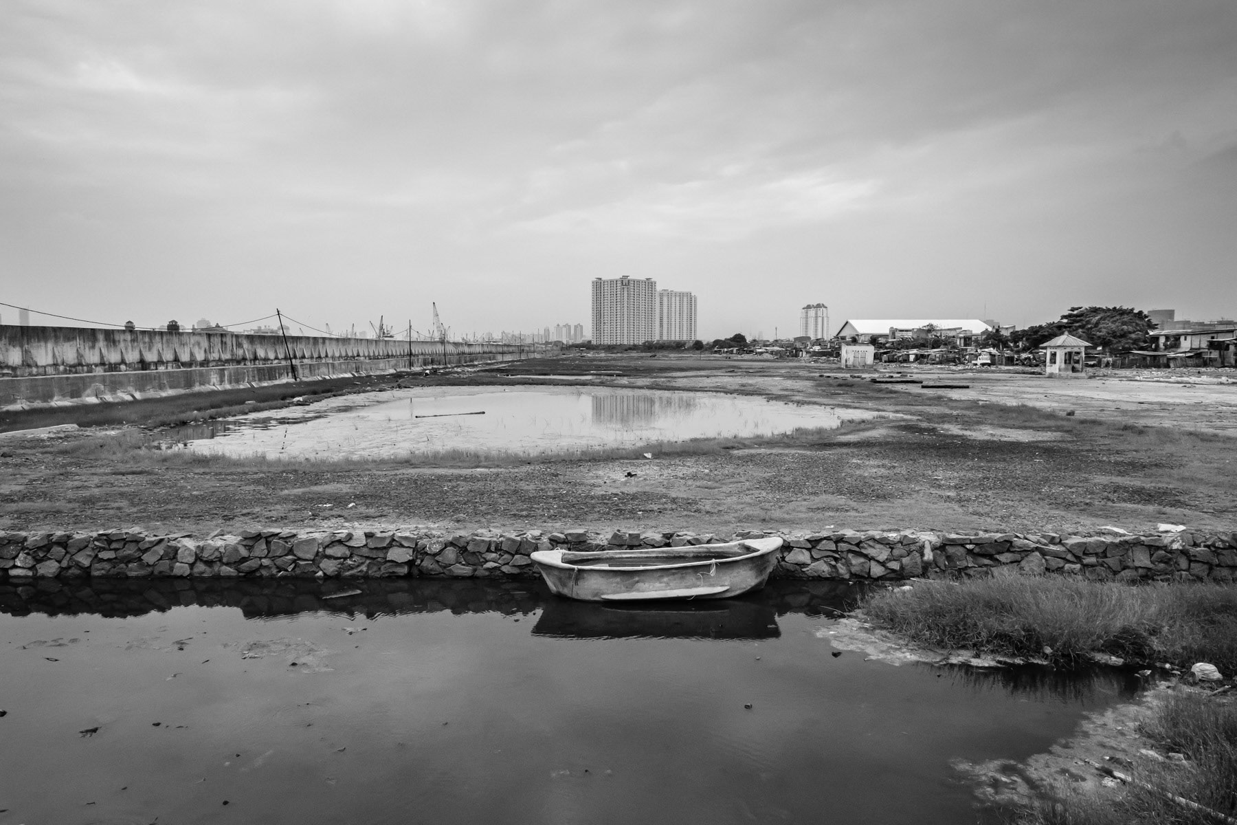Muara Buru neighbourhood is partly protected by a seawall against rising sea levels and sinking soil. The soil is sinking at a rate of 10 to 20cm per year. The unstability of the ground is provoked by widespread drilling of water wells for new real estate projects, creating huge air pockets once the water is exhausted. North Jakarta, Indonesia, March 2020