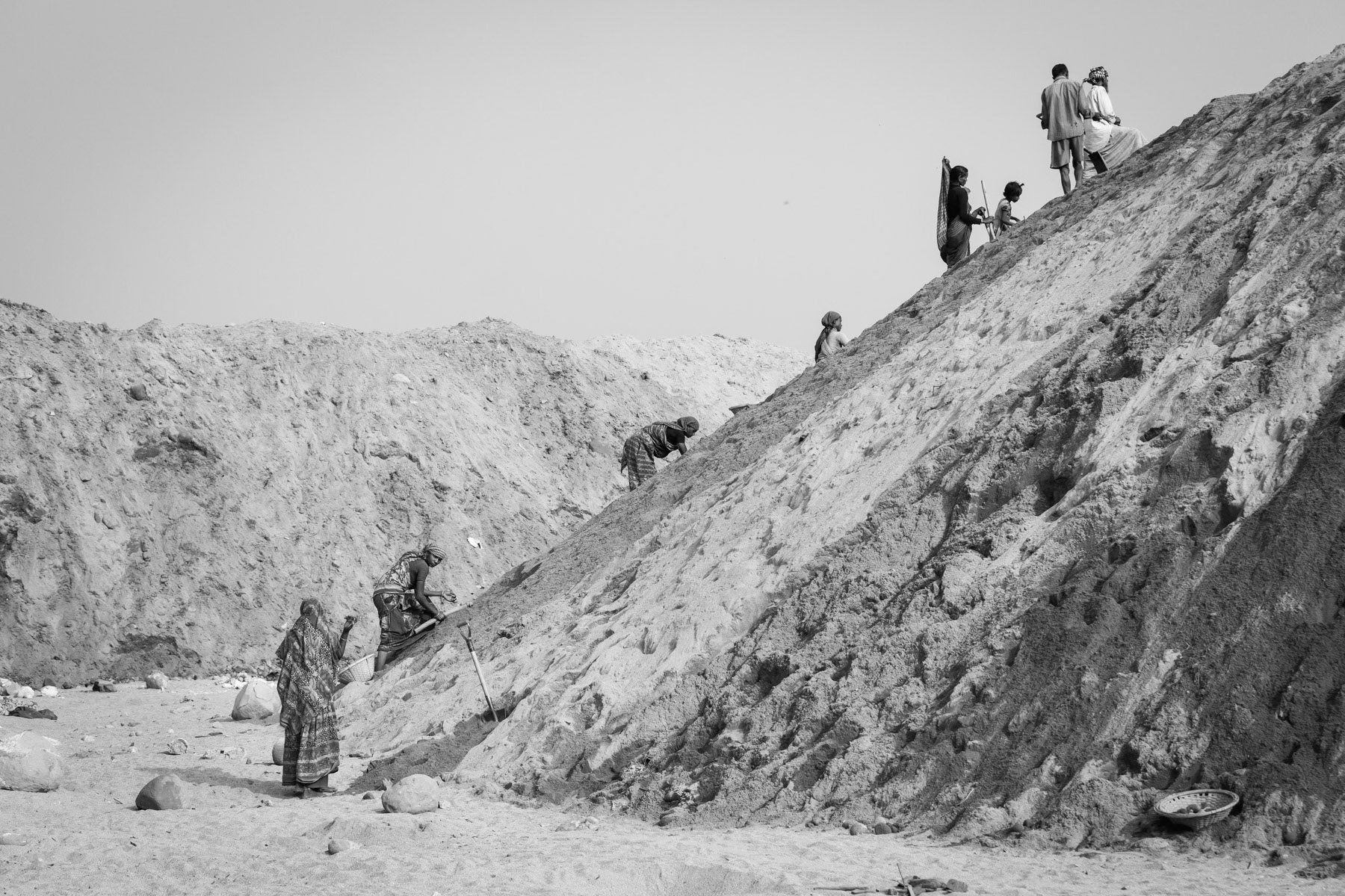 Seasonal workers looking for small stones among the extracted riverbed sand, Jaflong, Bangladesh, December 2015