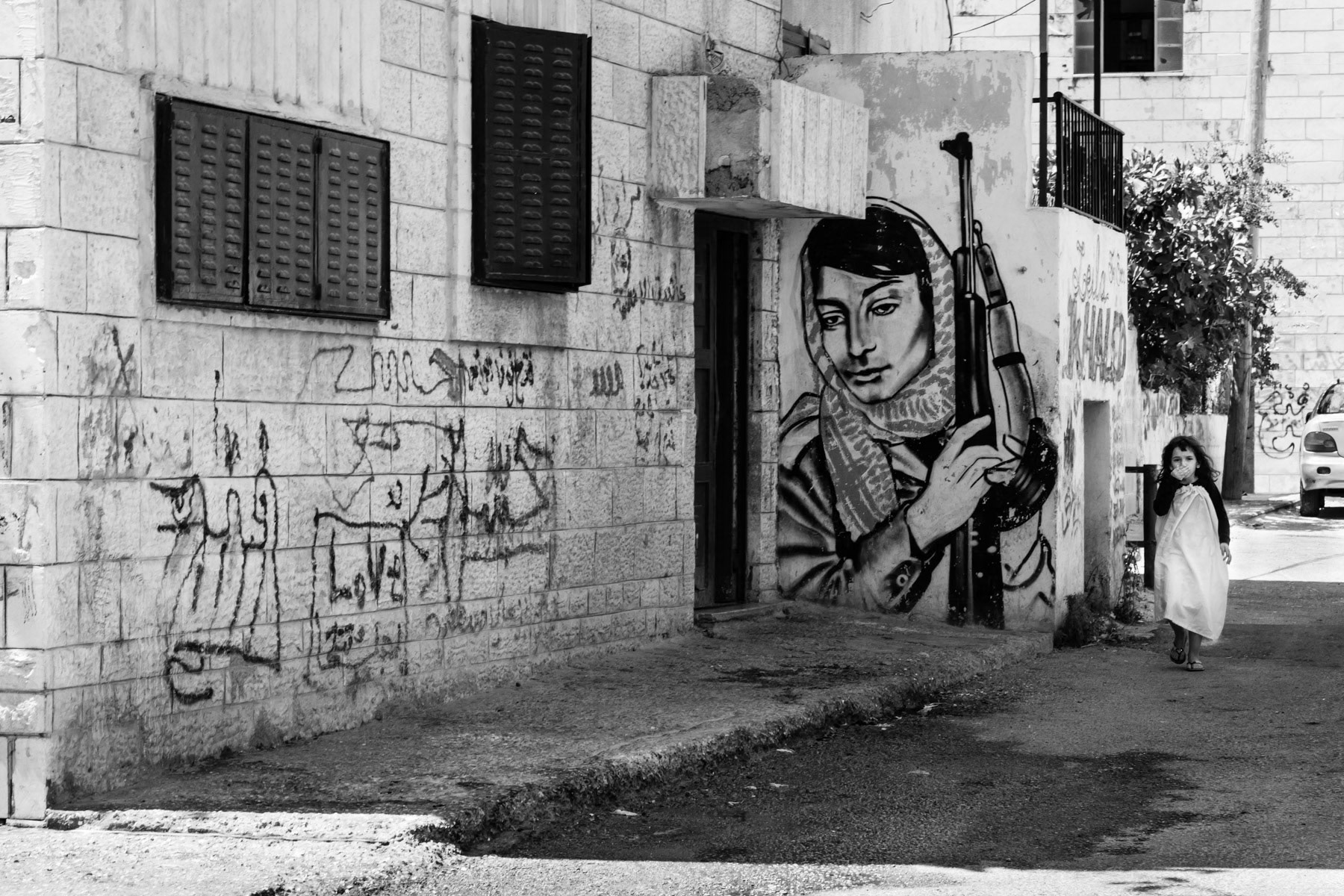 Palestinian girl walking through Aida refugee camp, Bethlehem, Palestine, July 2013