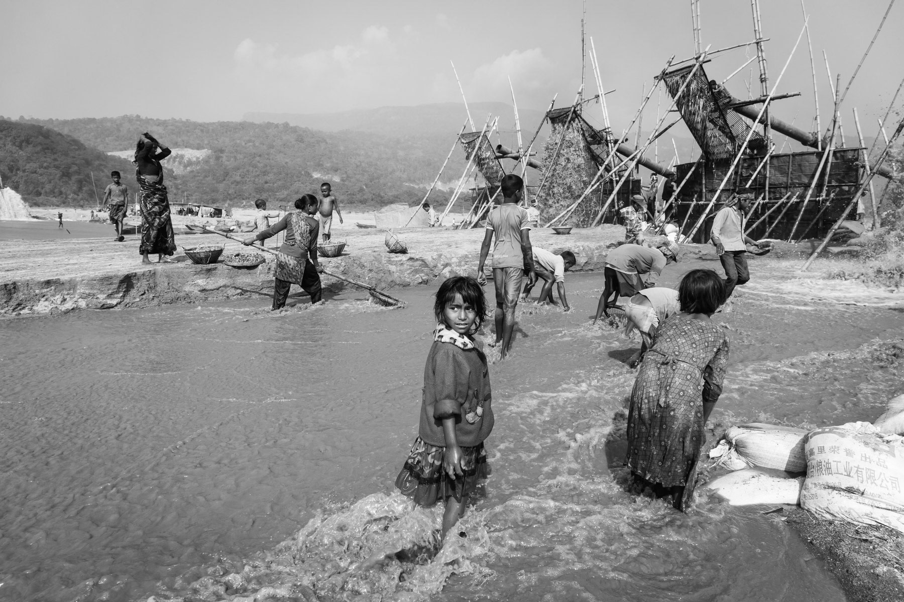 Children collecting small residual stones behind the extraction pumps, Bholaganj, Bangladesh, December 2015