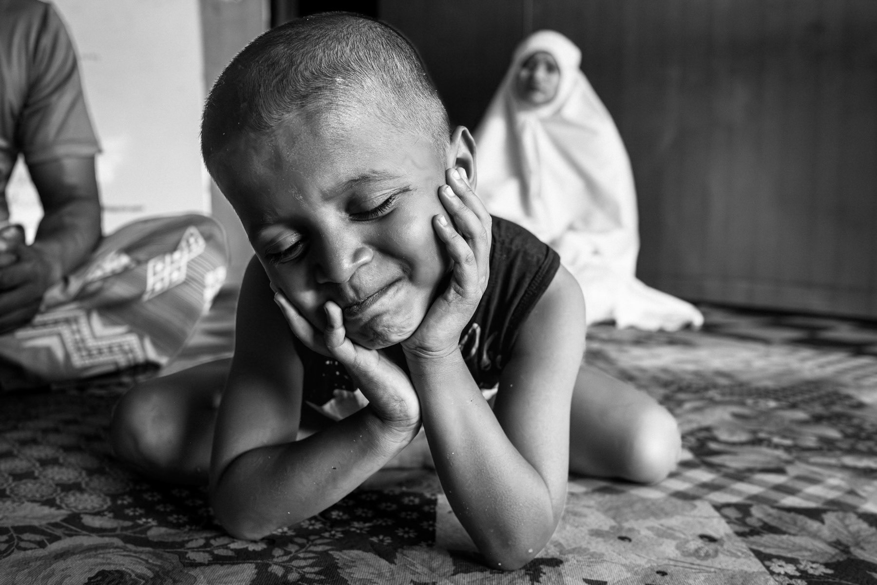 Nur Kolima's youngest son, from Phen Daw Phin village near Maungdaw, fled Myanmar in May 2025 with her two children—an eight-year-old daughter and a six-year-old son—after months of intensified fighting between the Myanmar military (SAC) and the Arakan Army. Her husband, Rafik, had already escaped in December 2024 after being tortured, travelling through Malaysia before reaching Indonesia. Nur and the children initially intended to flee to relatives in the Bangladesh refugee camps, but after crossing the Naf River they were intercepted by traffickers and forced onto a boat. Upon arrival in Dumai, Indonesia, she was separated from her children and threatened until payment was made. The family has since been reunited, but all remain deeply traumatized by the violence in their home country and the ordeal of being trafficked. Pekanbaru, Indonesia, October 2025