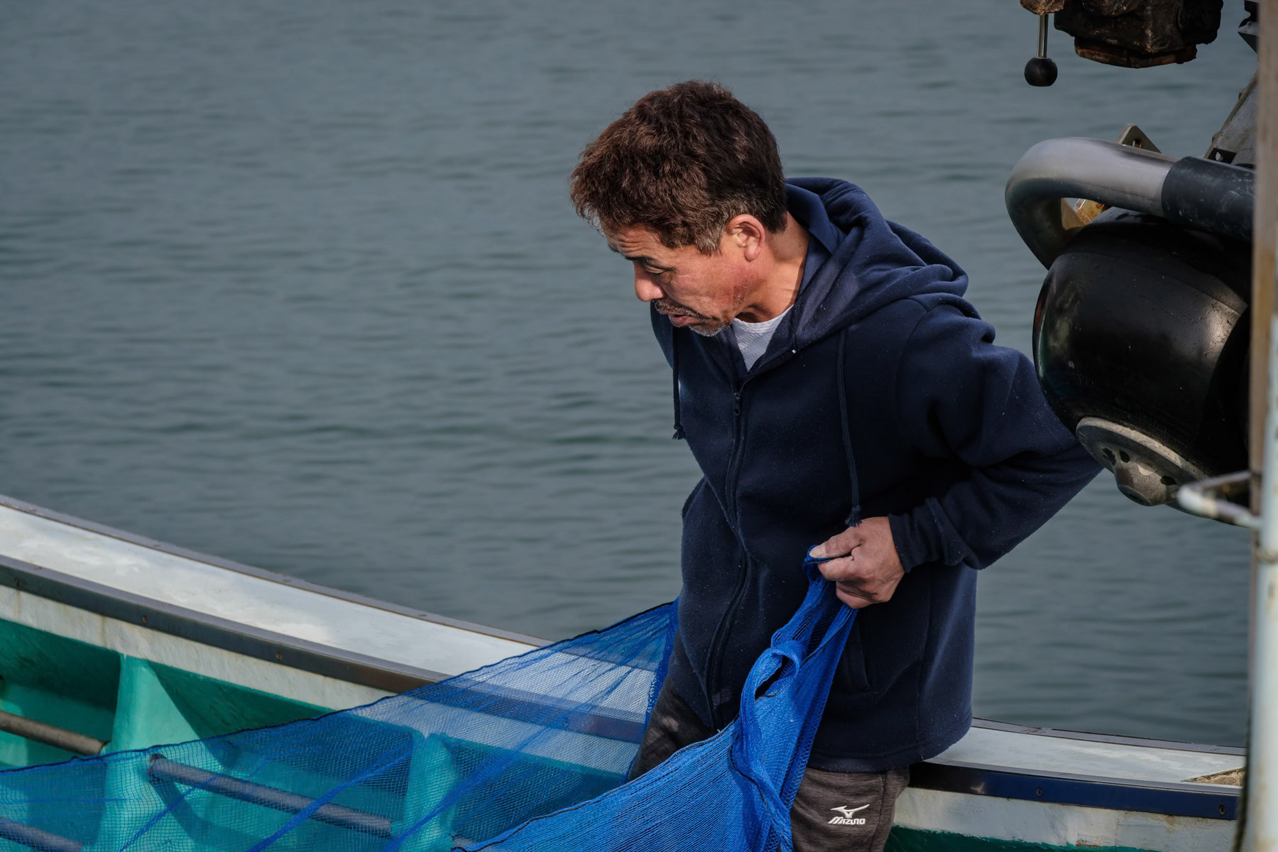 Fisherman checking his nets after returning to a fishing port about 40 Km north of the Fukushima nuclear power plant where treated cooling water is being released in the ocean after the green light of the international agency for nuclear energy. Soma, Fukushima, Japan, October 2023
