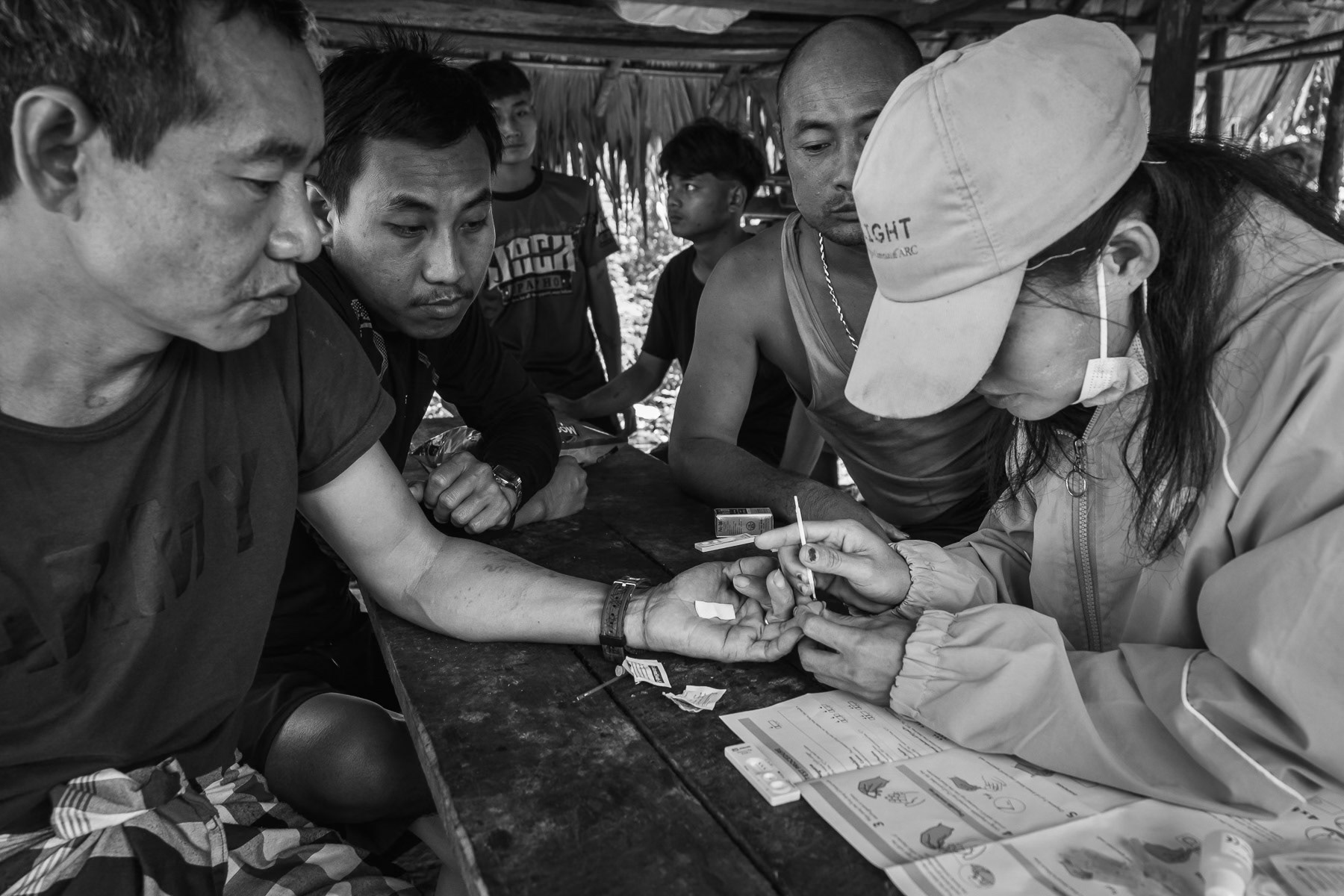A nurse from the Karen National Union health services carrying out a malaria test to KNLA soldiers on the frontline in Karen State, Myanmar, September 2024