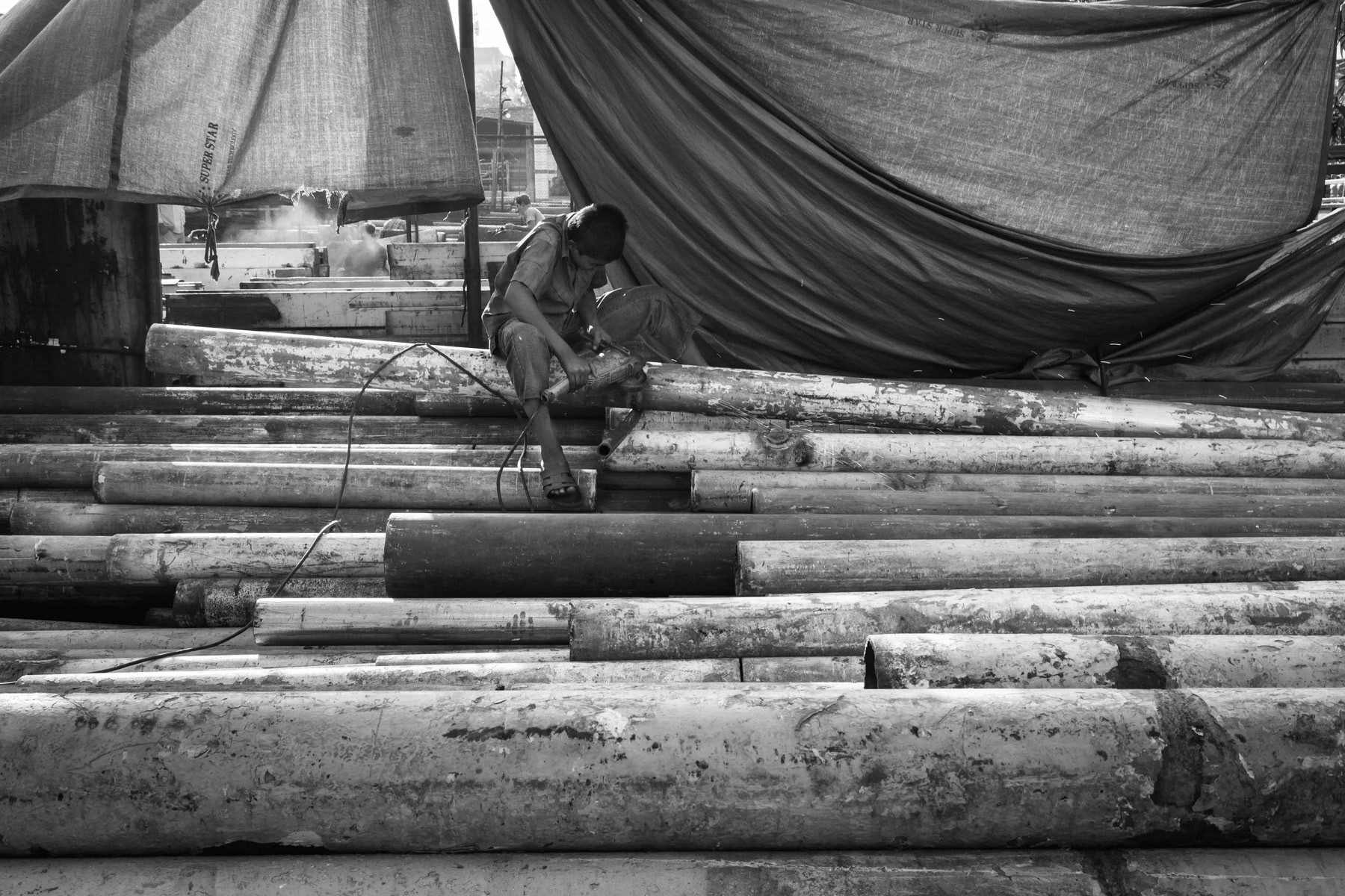 Boy cutting boat pipes, Bhatiary ship breaking yards, Bangladesh, October 2014