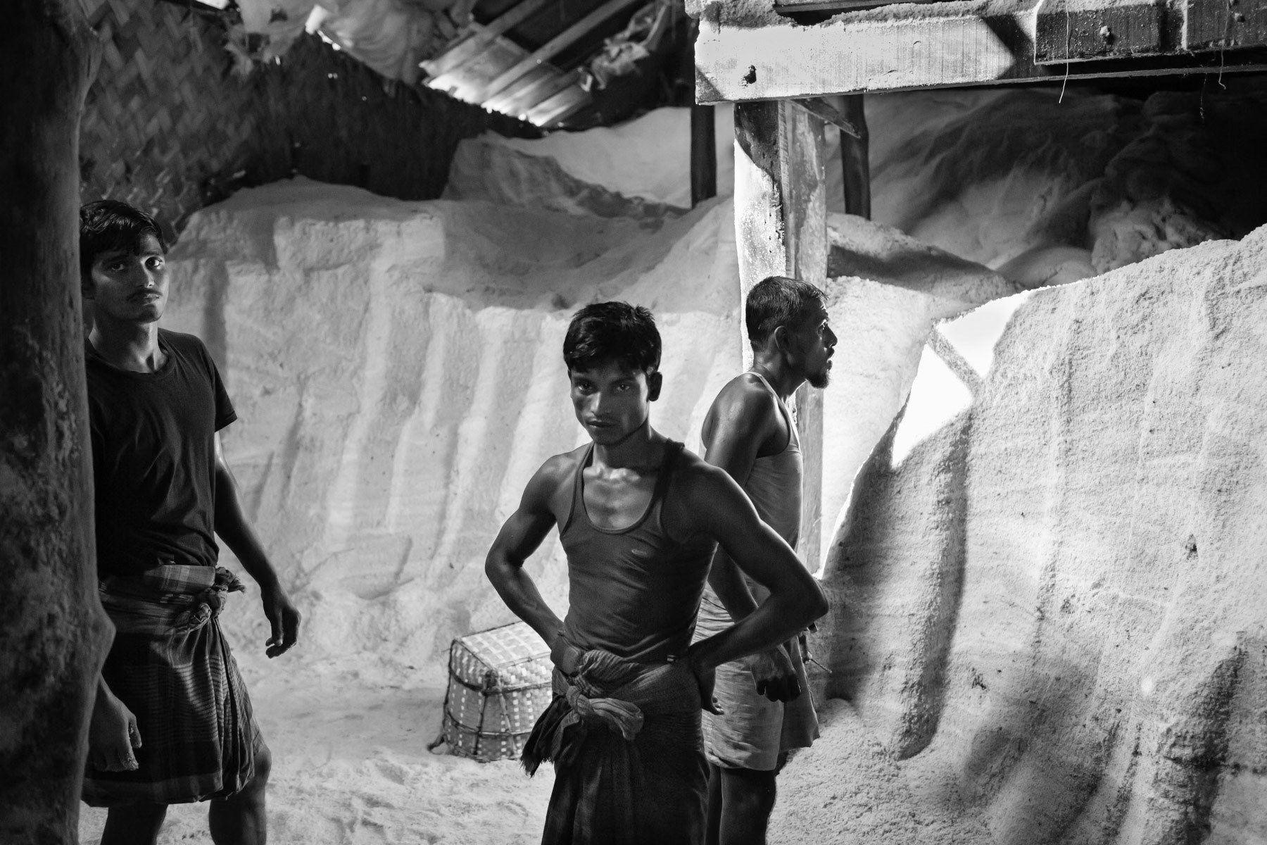 Ideally located along the Karnaphuli river in Chittagong and only several hours from the Bay of Bengal salt fields, the salt processing plants cater huge quantities of salt for Bangladesh's ever growing leather industry where salt is needed to preserve the raw animal skins. Workers storing salt in a processing plant, Chittagong dockyards in Sadarghat, Bangladesh, October 2014