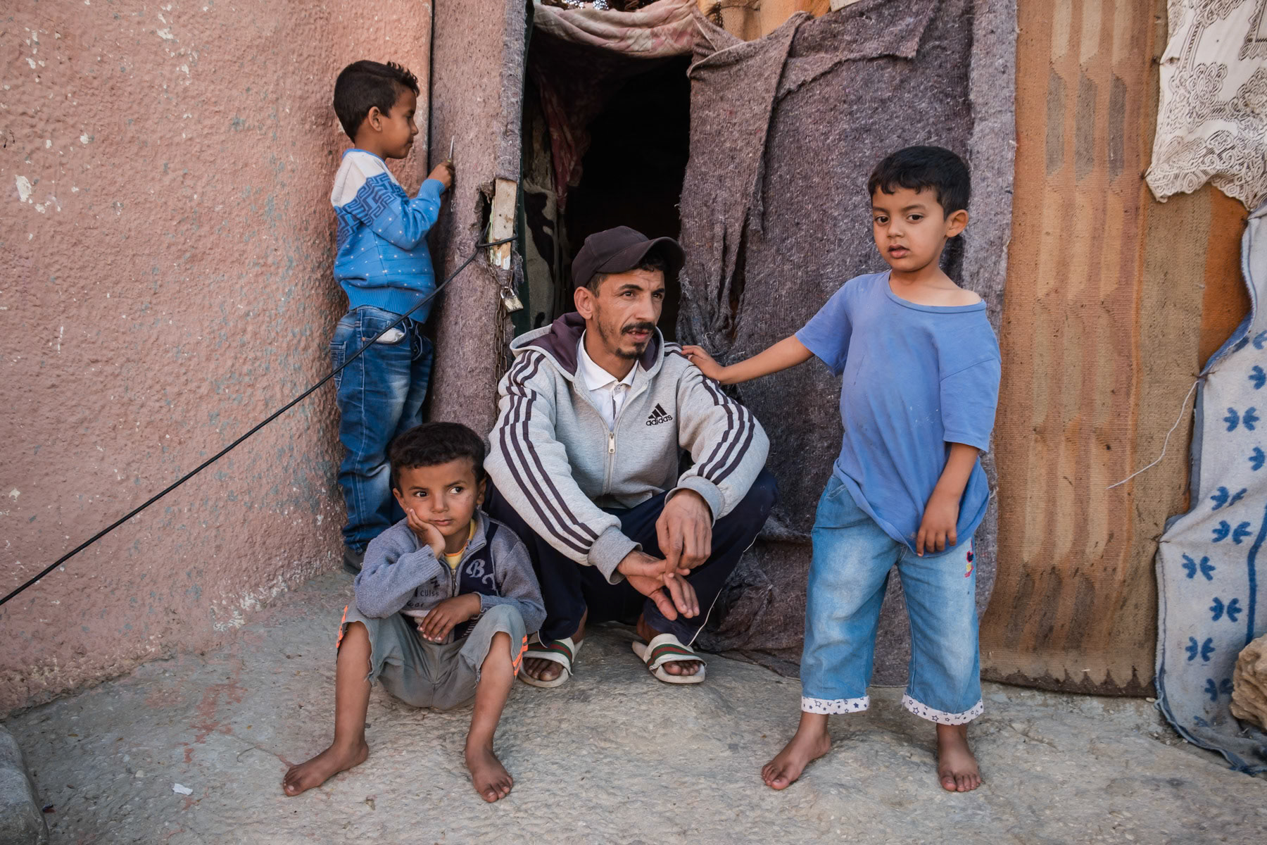 A father and his sons in front of his modest dwelling, Laayoune, Western Sahara, December 2018
