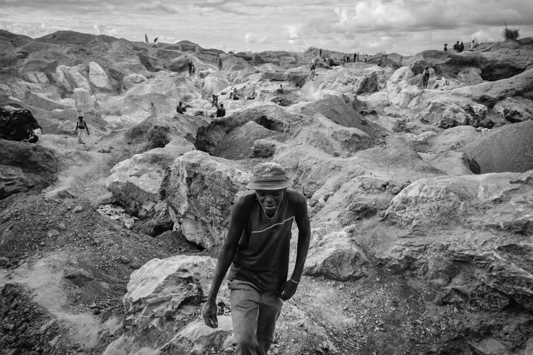 Makululu open pit mine where galena, the mineral form of lead, and dolomite a source of magnesium oxide are being mined by the local community. All labour, including stone crushing is done by hand. Rocks are being burned to make them softer before being extracted. Kabwe, Zambia, May 2021