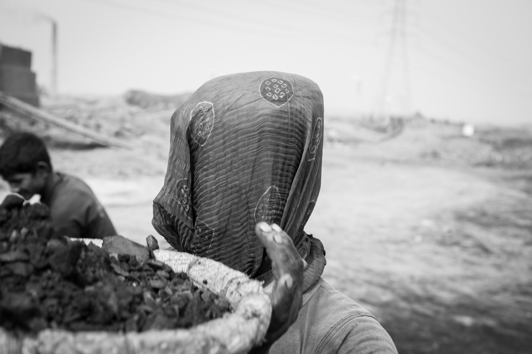 Carrying coal to the heart of the brick kiln. The fire in the brick kiln will be maintained throughout the 8 months production period during which air pollution in and around Dhaka reach alarming levels, Amin Bazar brick kilns in Dhaka suburbs, Bangladesh, December 2015