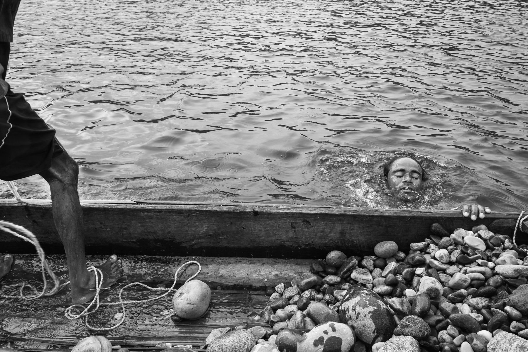 Diver fetching stones at a depth 4 to 8m in the Goyain river near Tamabil, Bangladesh, May 2016