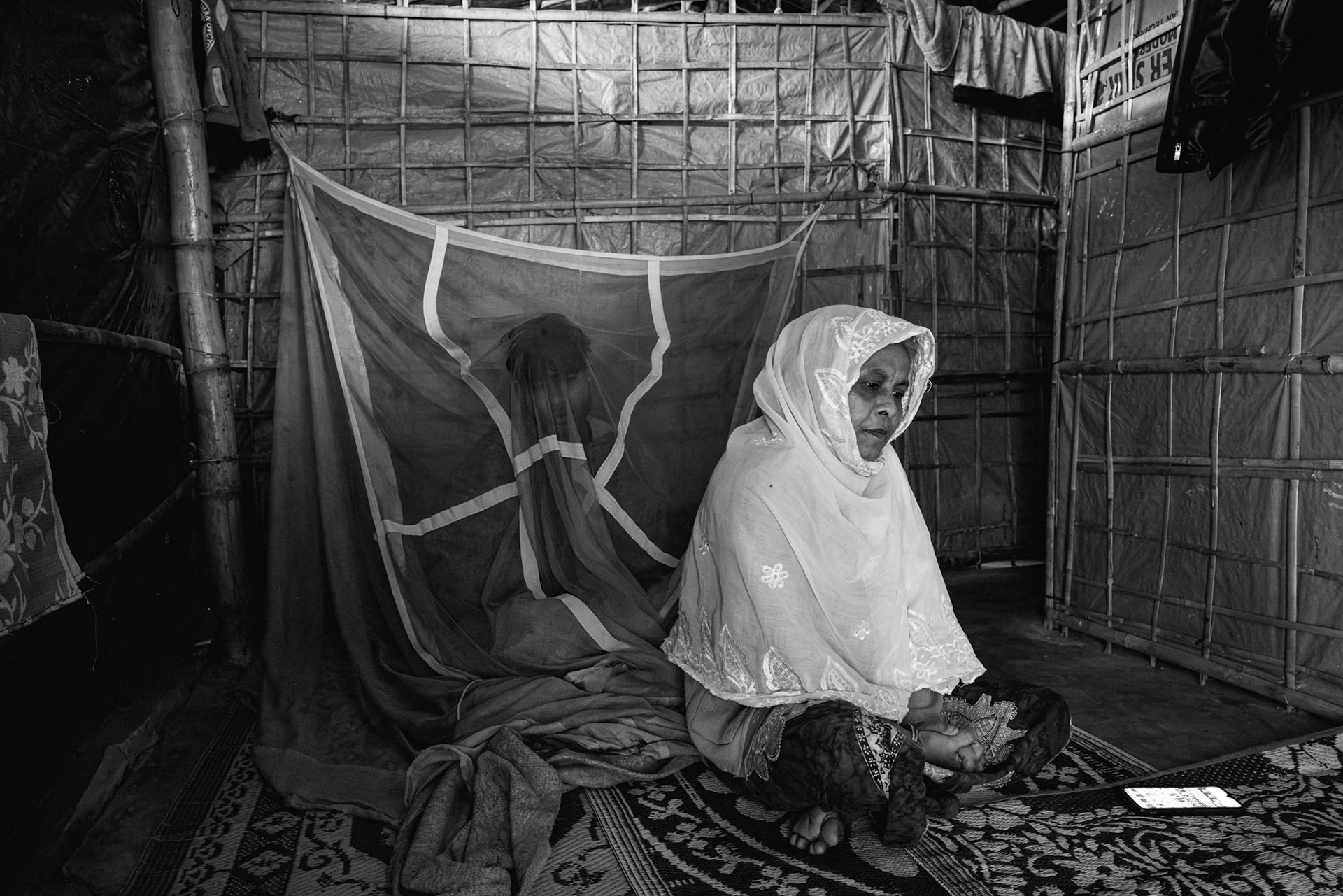 Rohima Kathun, 52, from Etalya village, Maungdaw Township, Myanmar; husband Md Kassim, 55, killed in a drone strike on their home during an attack by the Arakan Army, now she lives alone and moves from shelter to shelter; Balukhali camp in Bangladesh, January 2026.