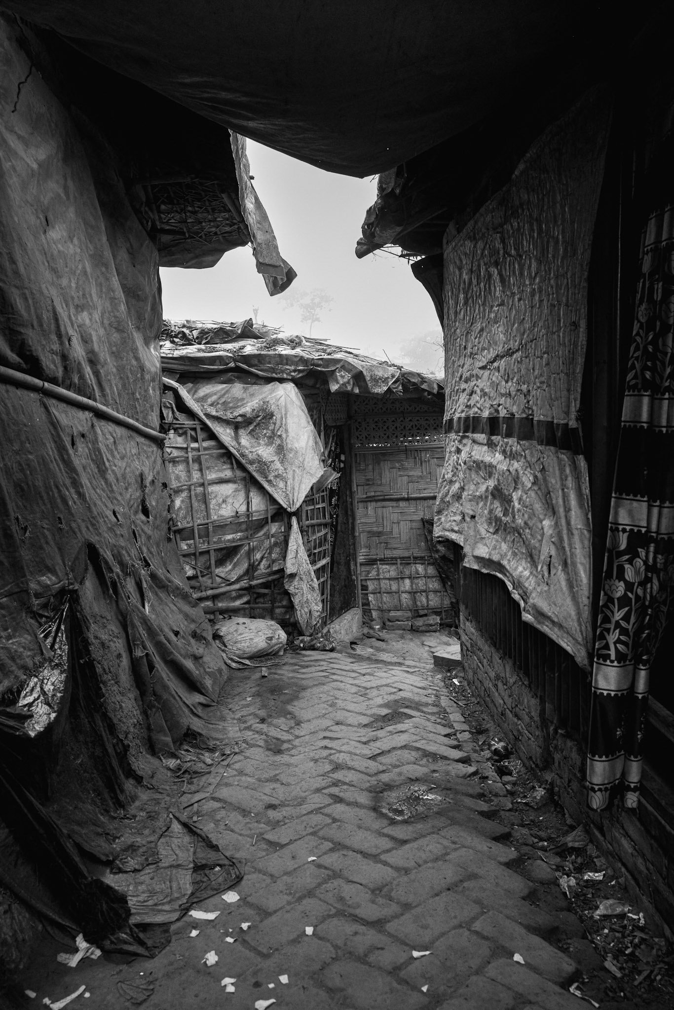 Life inside these dwellings is defined by extreme heat and lack of space, as families of ten or more often share a single small room. Balukhali camp, Bangladesh, January 2026