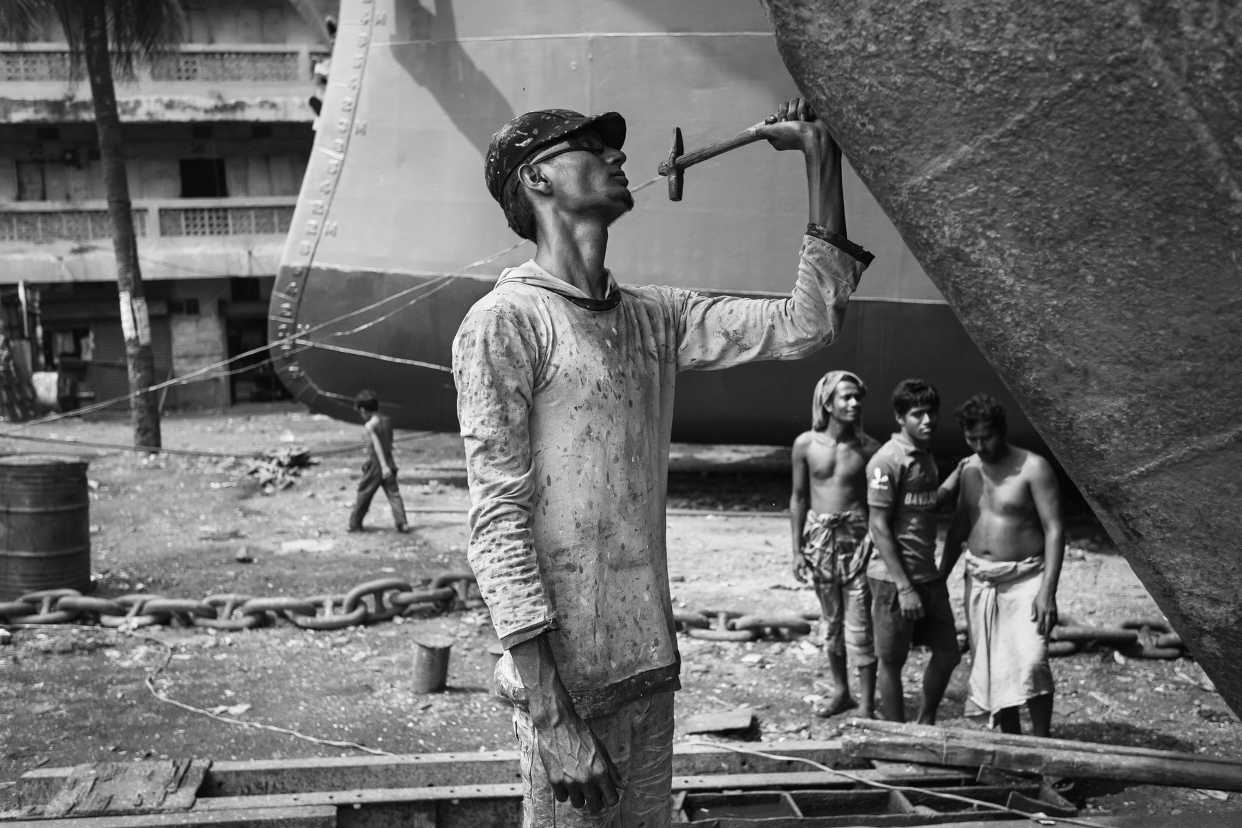 Removing old paint from the hull, Dhaka shipyards, Bangladesh, October 2014
