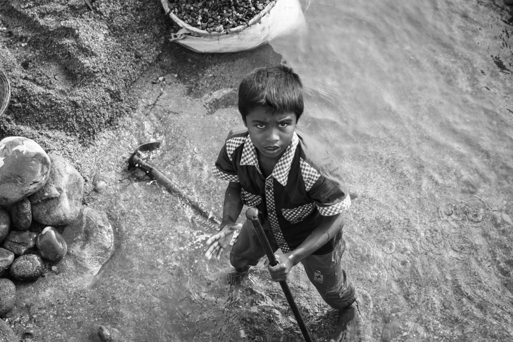 Child collecting stones in Goyain river bed, Jaflong in Bangladesh, December 2015