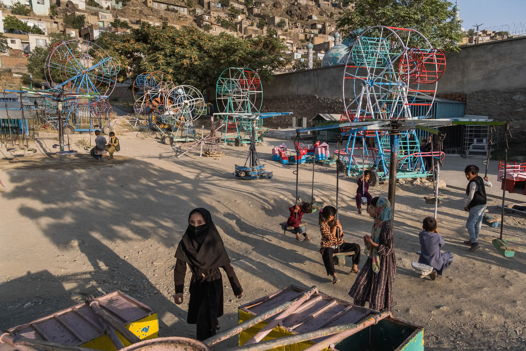 Children at a playground. Once passed the age of 12, girls and women are forbidden to access parks and public places for leisure. Since taking over Afghanistan in 2021, the Taliban have relentlessly restricted women from being part of society by banning education, work and cultural activities. A de facto 'No women's land' and gender apartheid is being established. Afghanistan, August 2024
