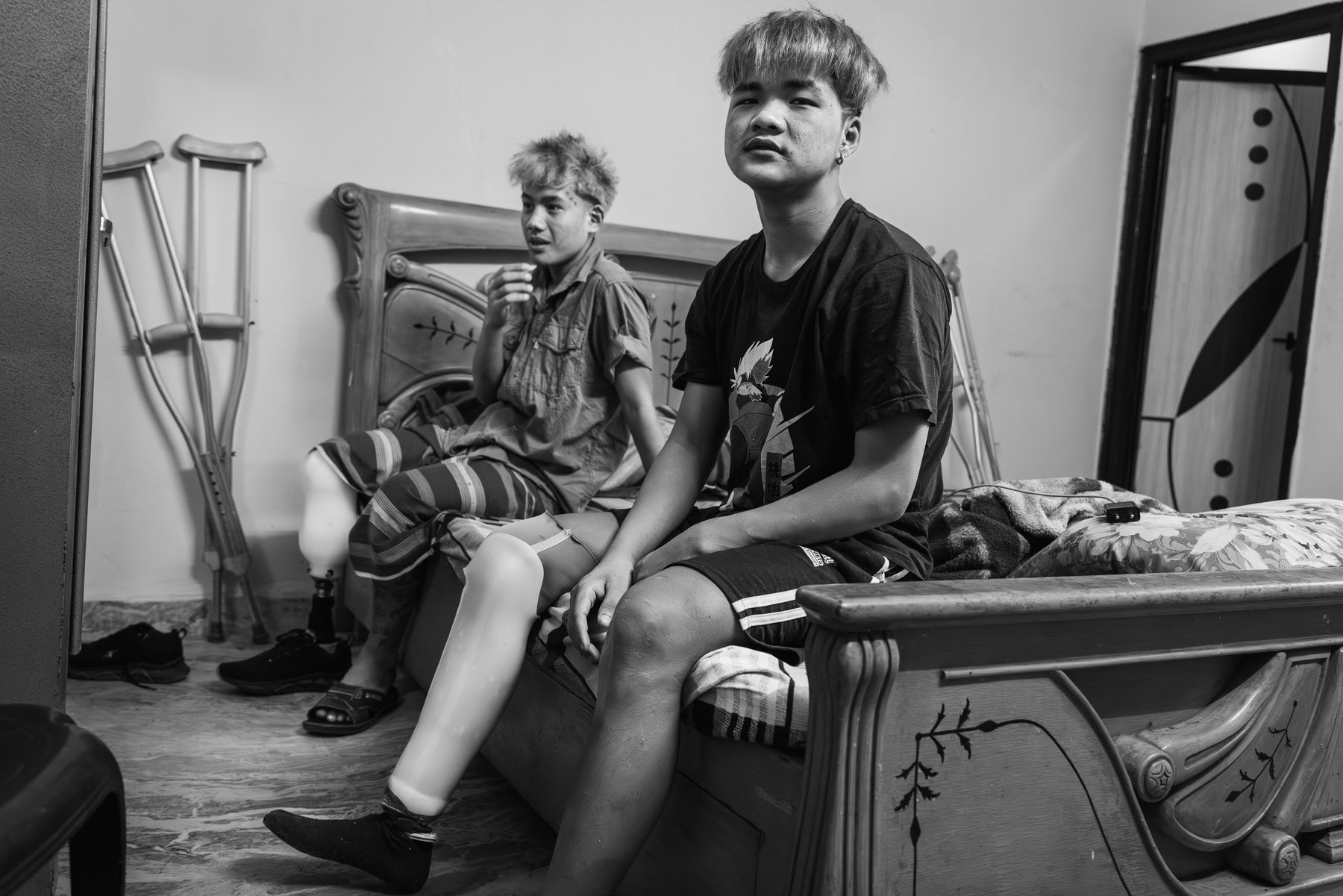 Tham Nay and Shing Om (in the background), are both 19 years old and from Mindat in Chin State of Myanmar. Both were since the start of the revolution engaged with the resistance forces in Chin and Magway regions. In October 2023 they stepped on a mine and had their right lig amputated. It took nearly 2 weeks to have them evacuated towards a proper hospital in India. They are now in New Delhi where they have entered a program to receive a prothesis, soon they will return to Myanmar and continue to support the revolution albeit in another role than as combatants. Chin community safehouse in New Delhi, India, April 2024