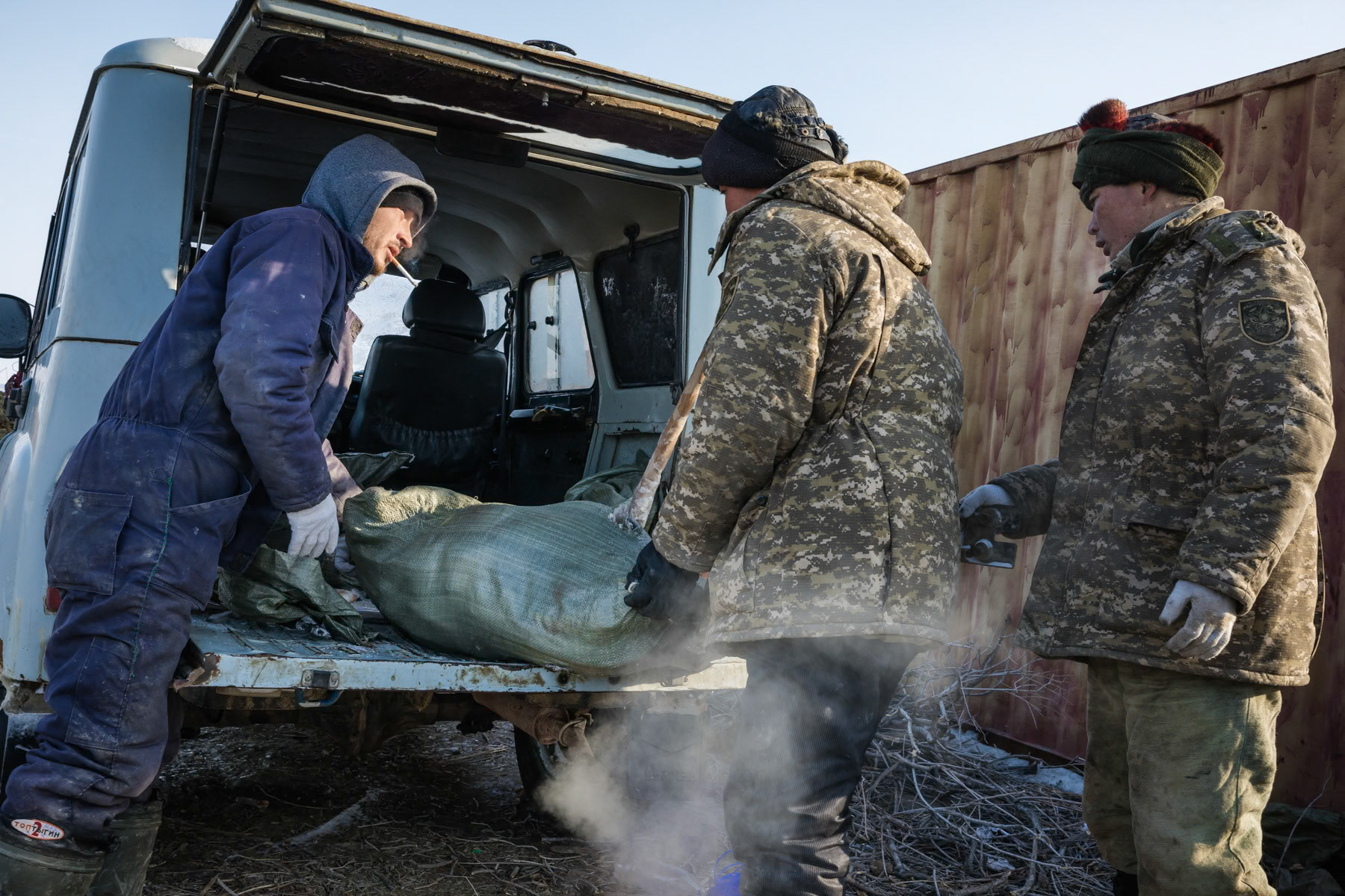 Loading fish for further transport and sale to the city of Aralsk. Base camp on the Aral Sea, Kazakhstan, January 2019