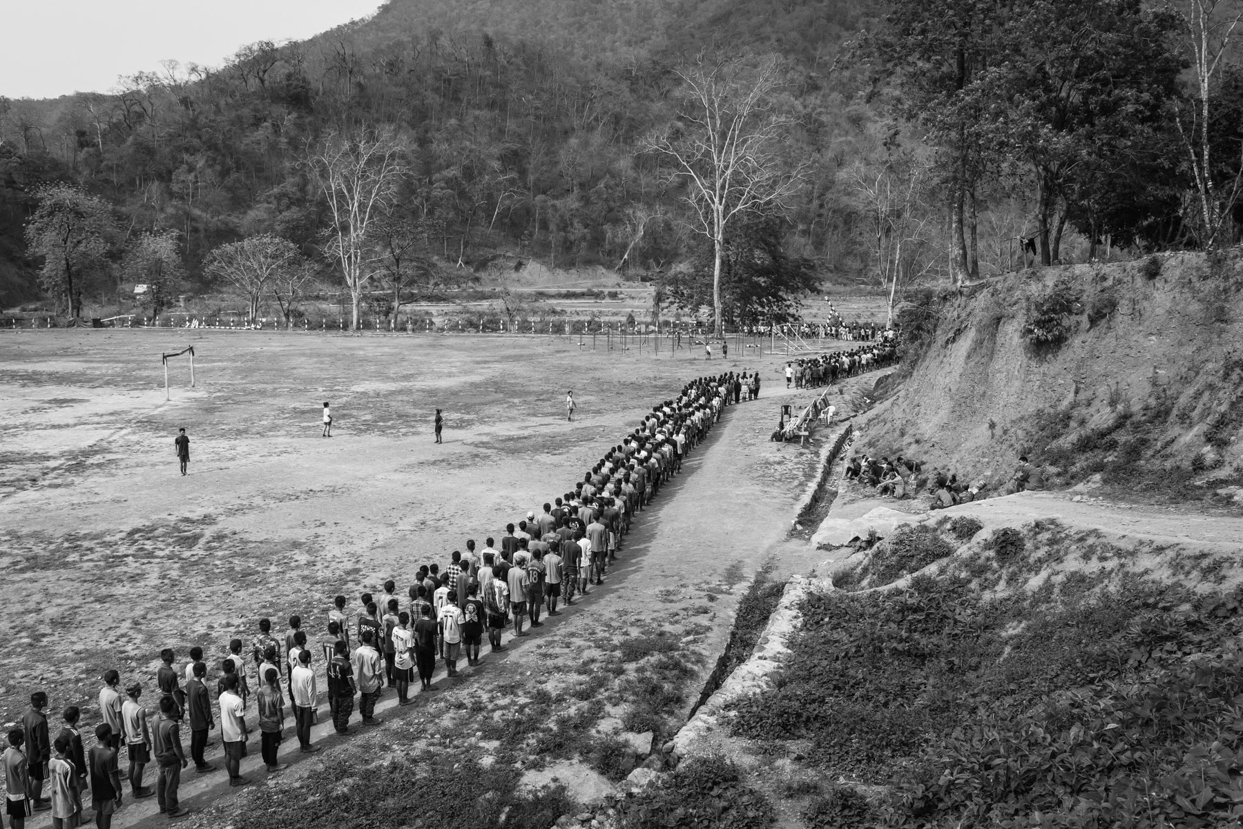New recruits for the Chin National Army (CNA) doing physical exercises during their lenghty training before integrating the CNA. The ever increasing air strikes and forced military service enacted by the military dictatorship, has substantially increased the number of people that engage and seek refuge with the ethnic armed groups opposing the military coup leaders. CNA HQ, Camp Victoria in Chin State, Myanmar, April 2024