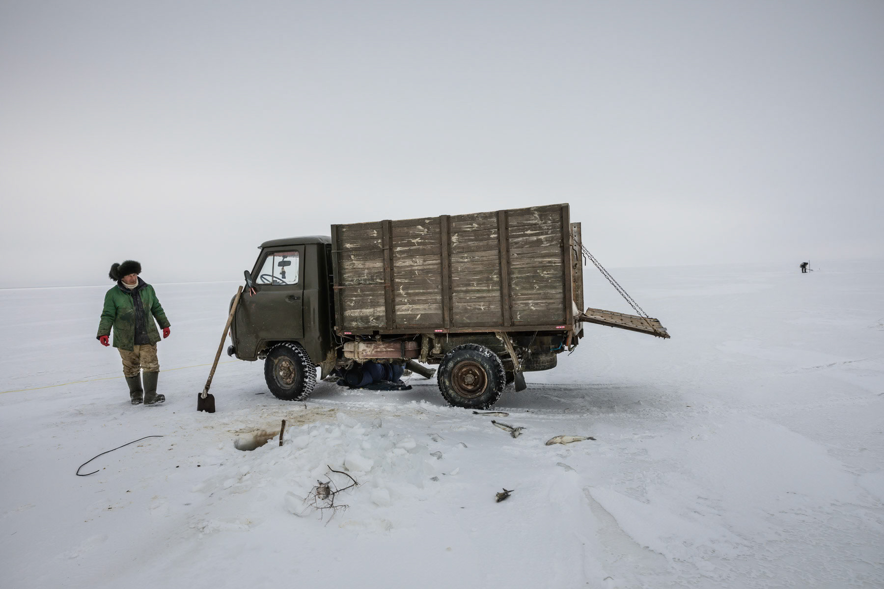 Fishermen on the frozen Aral Sea. The temperatures reach minus 20-30C during winter months and the ice fishing season lasts about 3-4 months. Aral Sea, Kazakhstan, January 2019